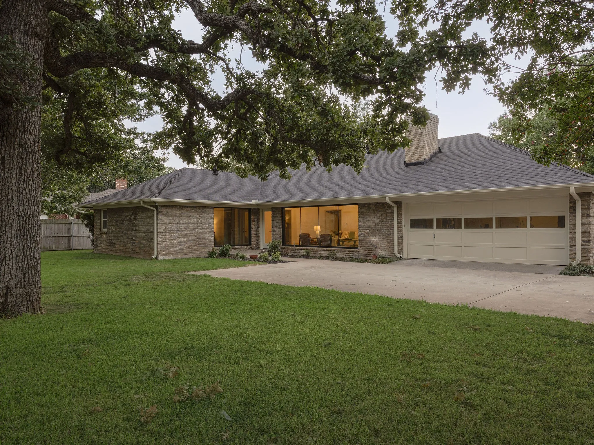 A spacious backyard framed by mature trees offers plenty of room to relax, entertain or make the space your own.