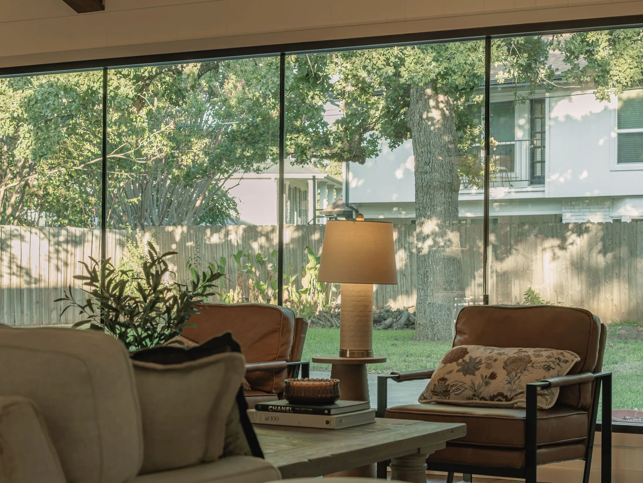 Oversized floor to ceiling windows fill the living room with natural light and create a seamless connection to the outdoors.