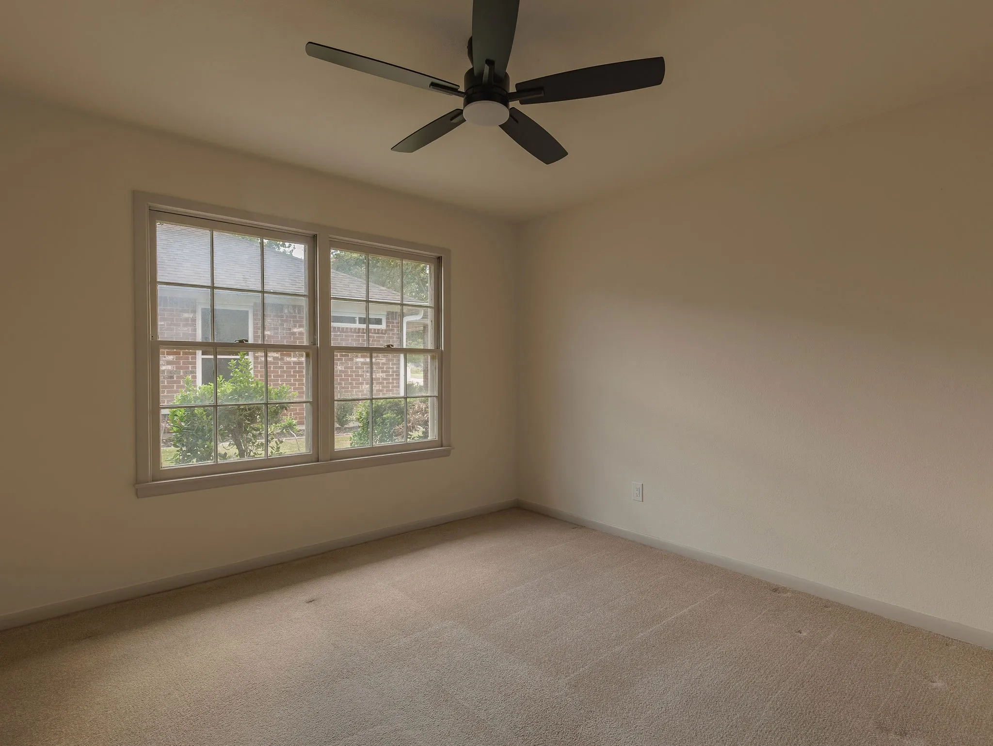 A comfortable secondary bedroom with soft natural light, ample closet storage and space to make it your own.