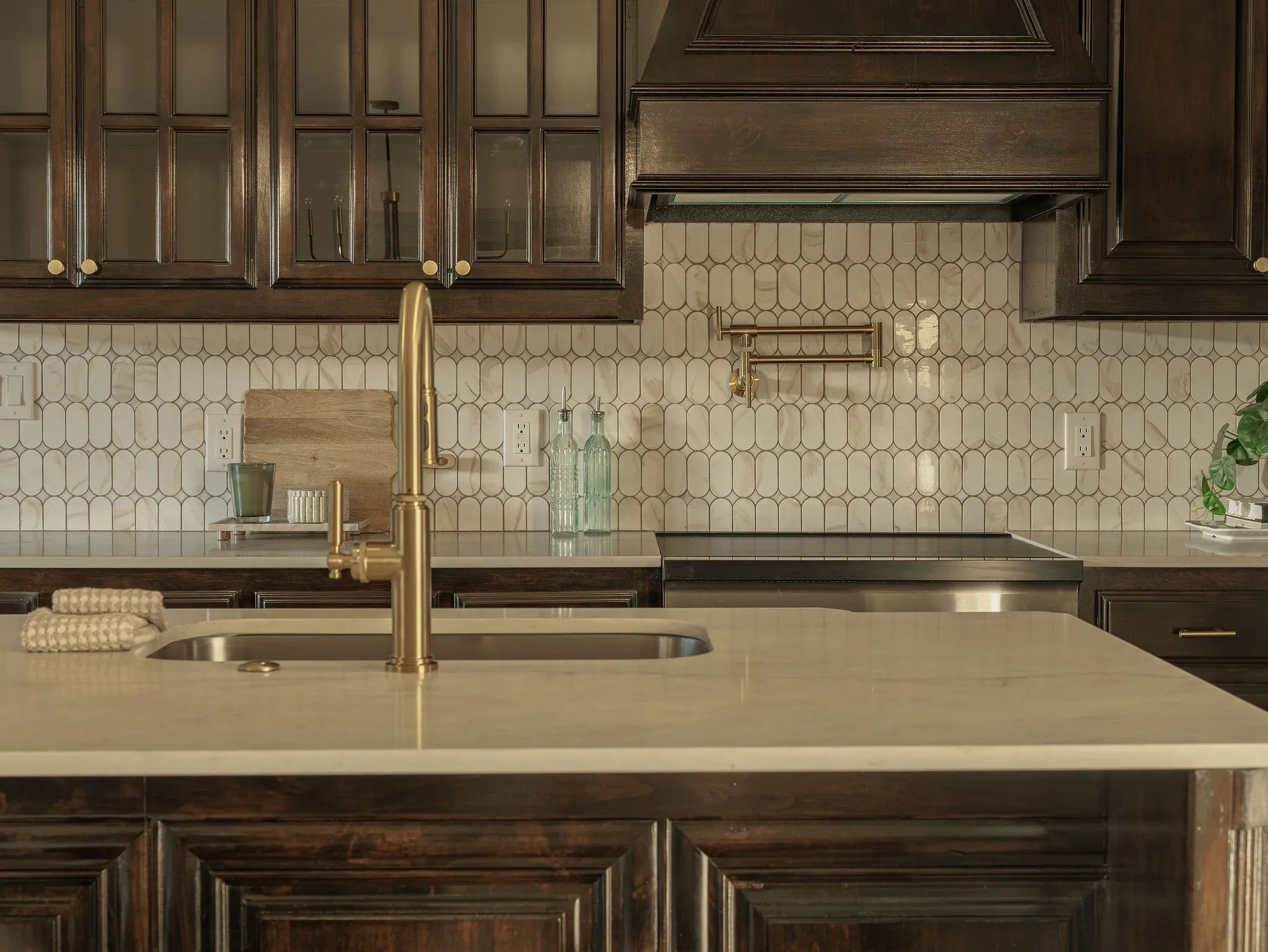 Custom dark walnut cabinetry anchors the redesigned kitchen.