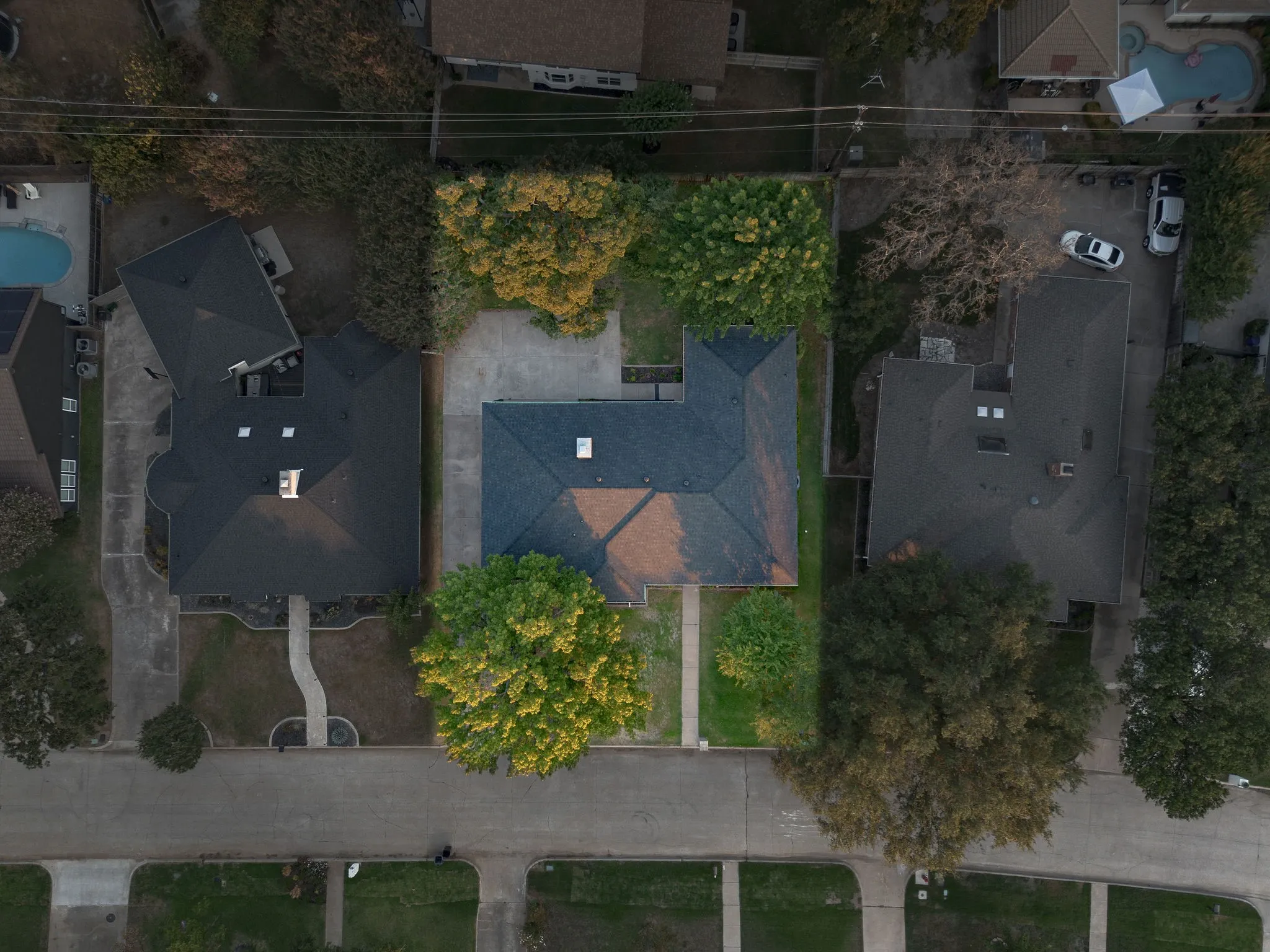 An aerial view highlights the home’s established setting, mature tree canopy and spacious lot.
