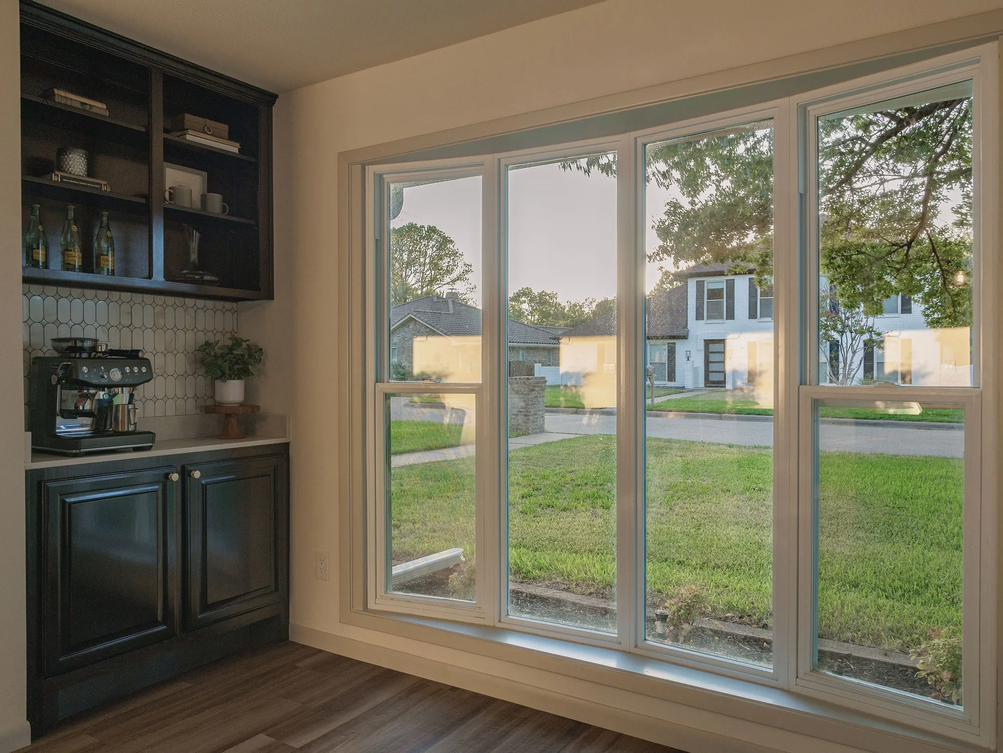 The breakfast area sits just beyond the kitchen with a dedicated coffee bar and abundant natural light, creating an easy space for everyday mornings.