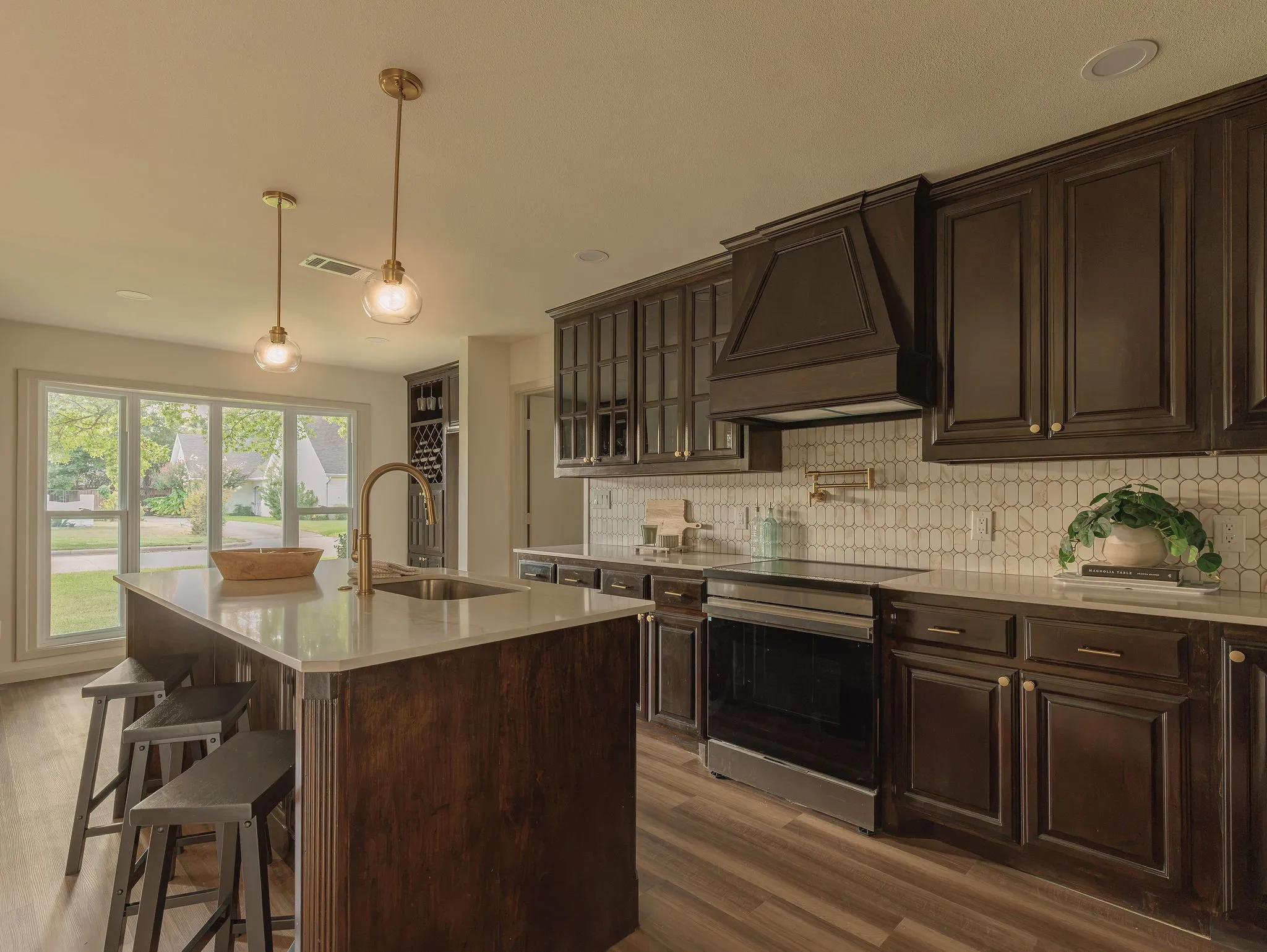 A beautifully reimagined kitchen with dark walnut custom cabinetry and quartz countertops.