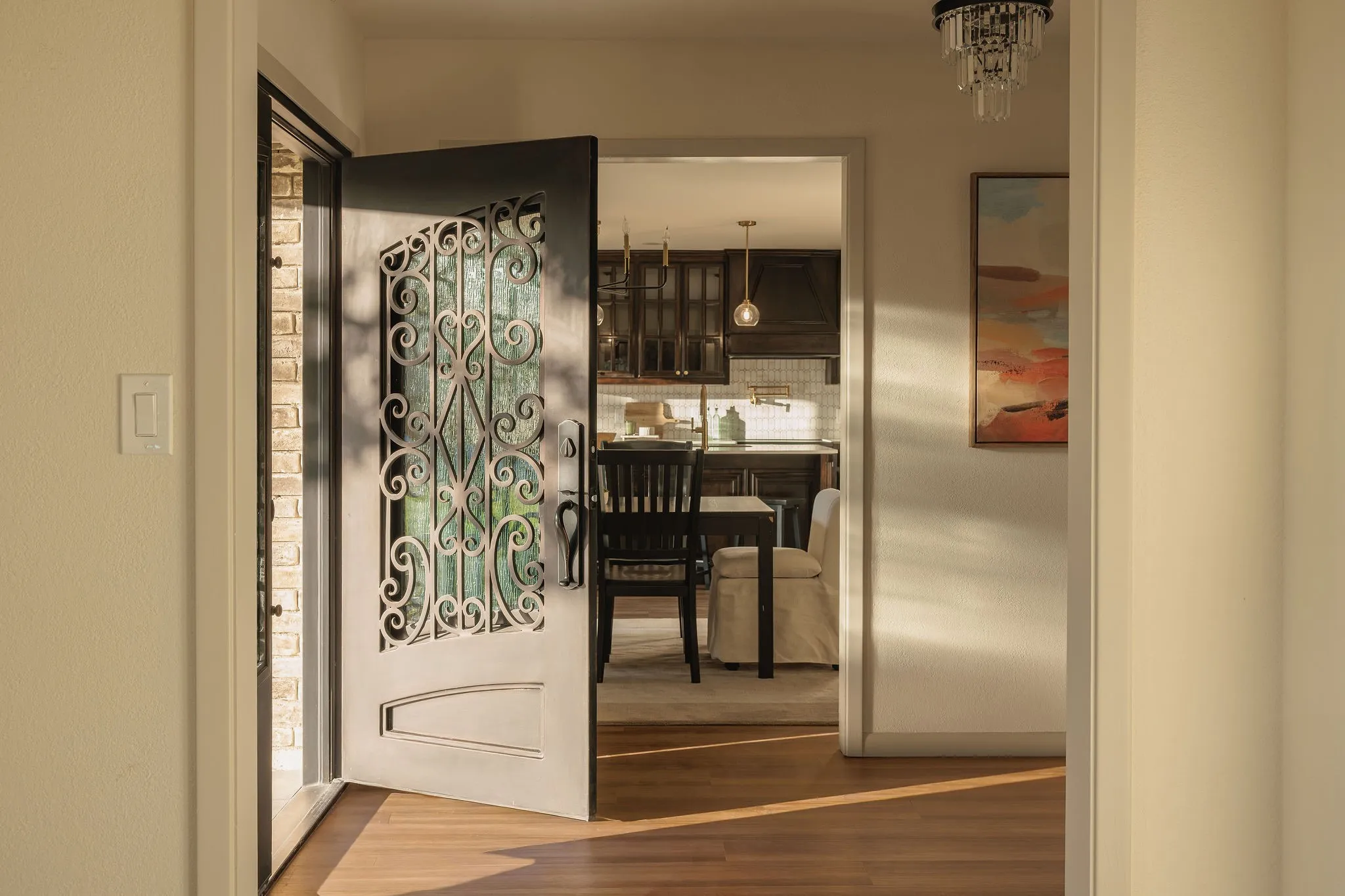 Custom iron double doors create a striking introduction to the home.