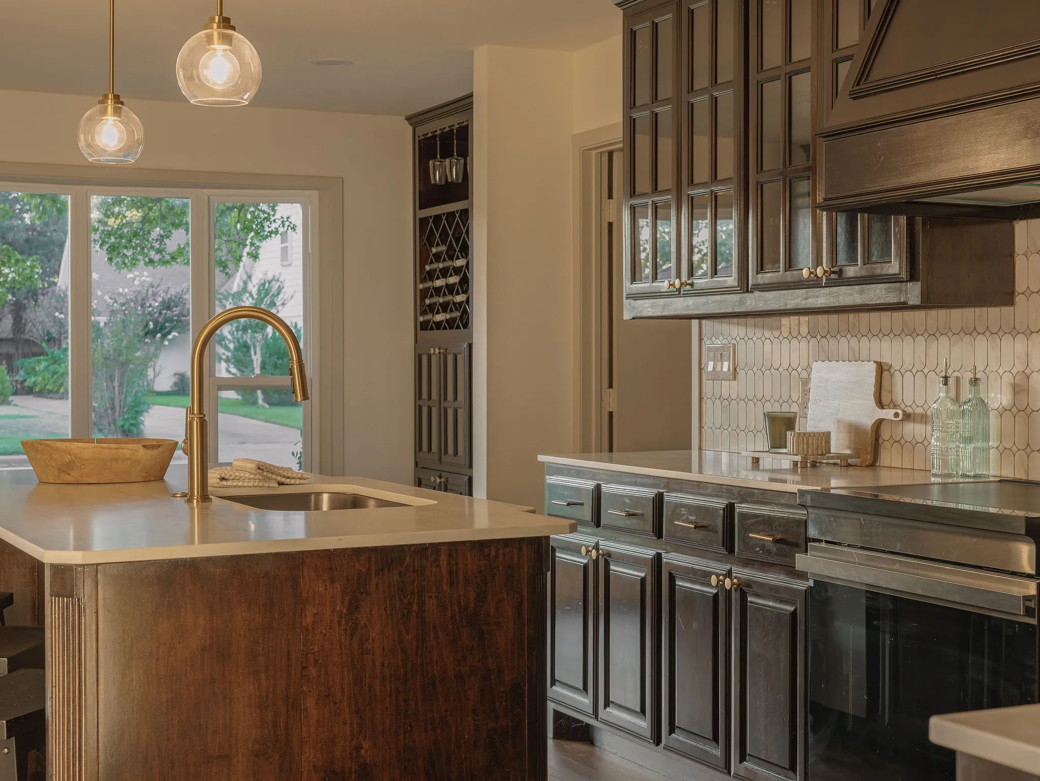 A beautifully reimagined kitchen with dark walnut custom cabinetry, undercabinet lighting and quartz countertops.