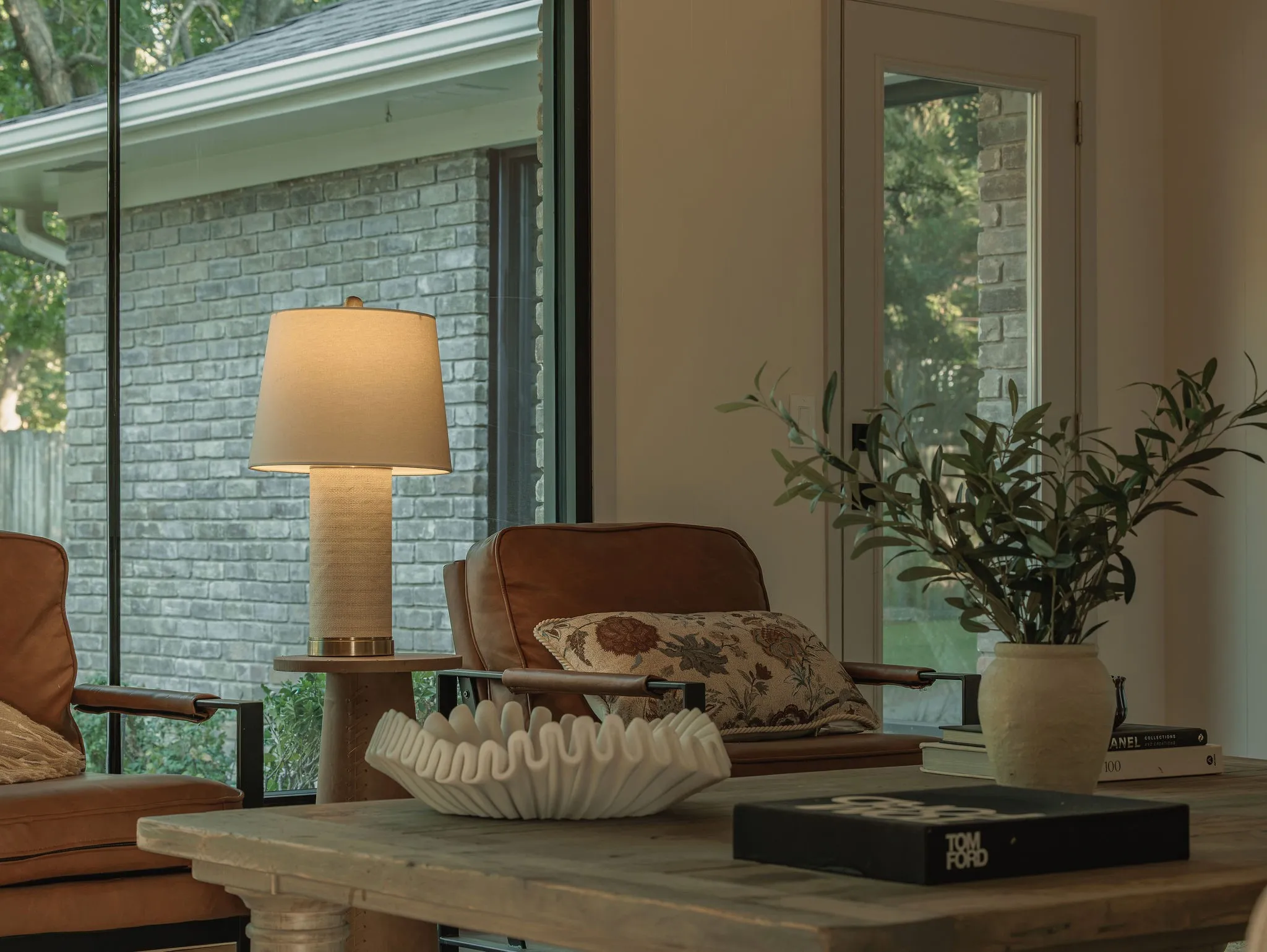A quiet corner of the living room framed by natural light and a seamless connection to the outdoors.
