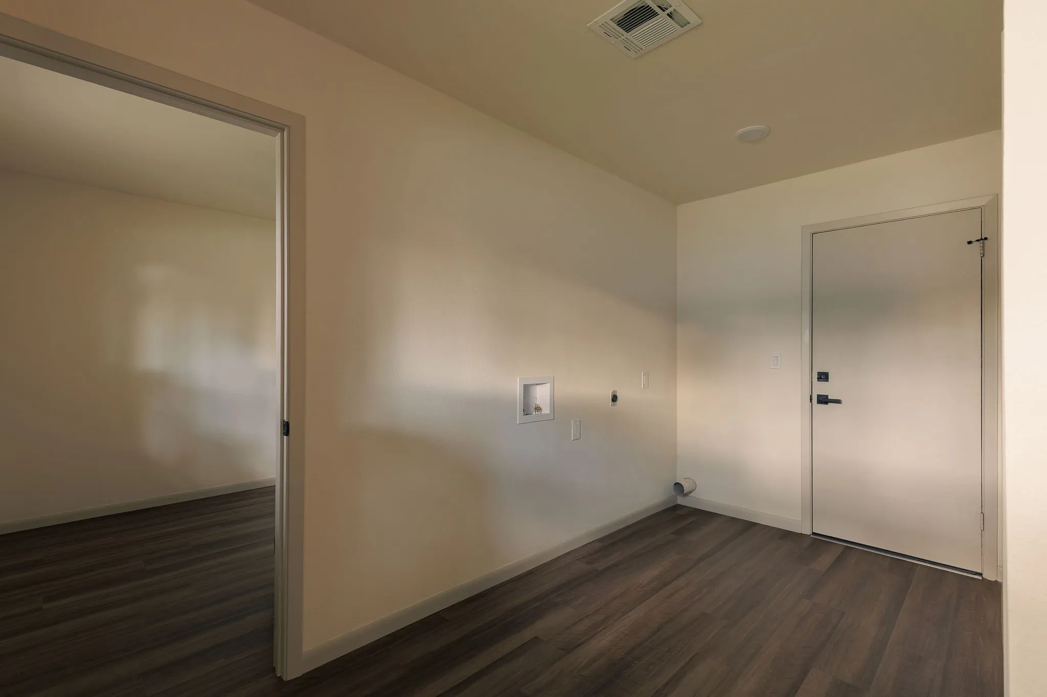 A spacious laundry room with additional room for storage and everyday organization.