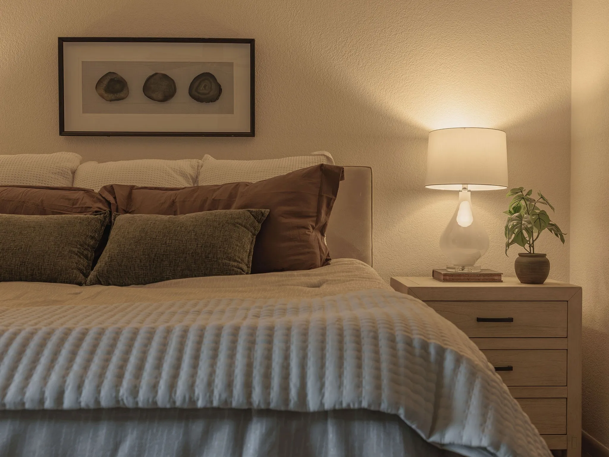 A spacious primary bedroom with layered architectural details and a private connection to the redesigned ensuite bath.