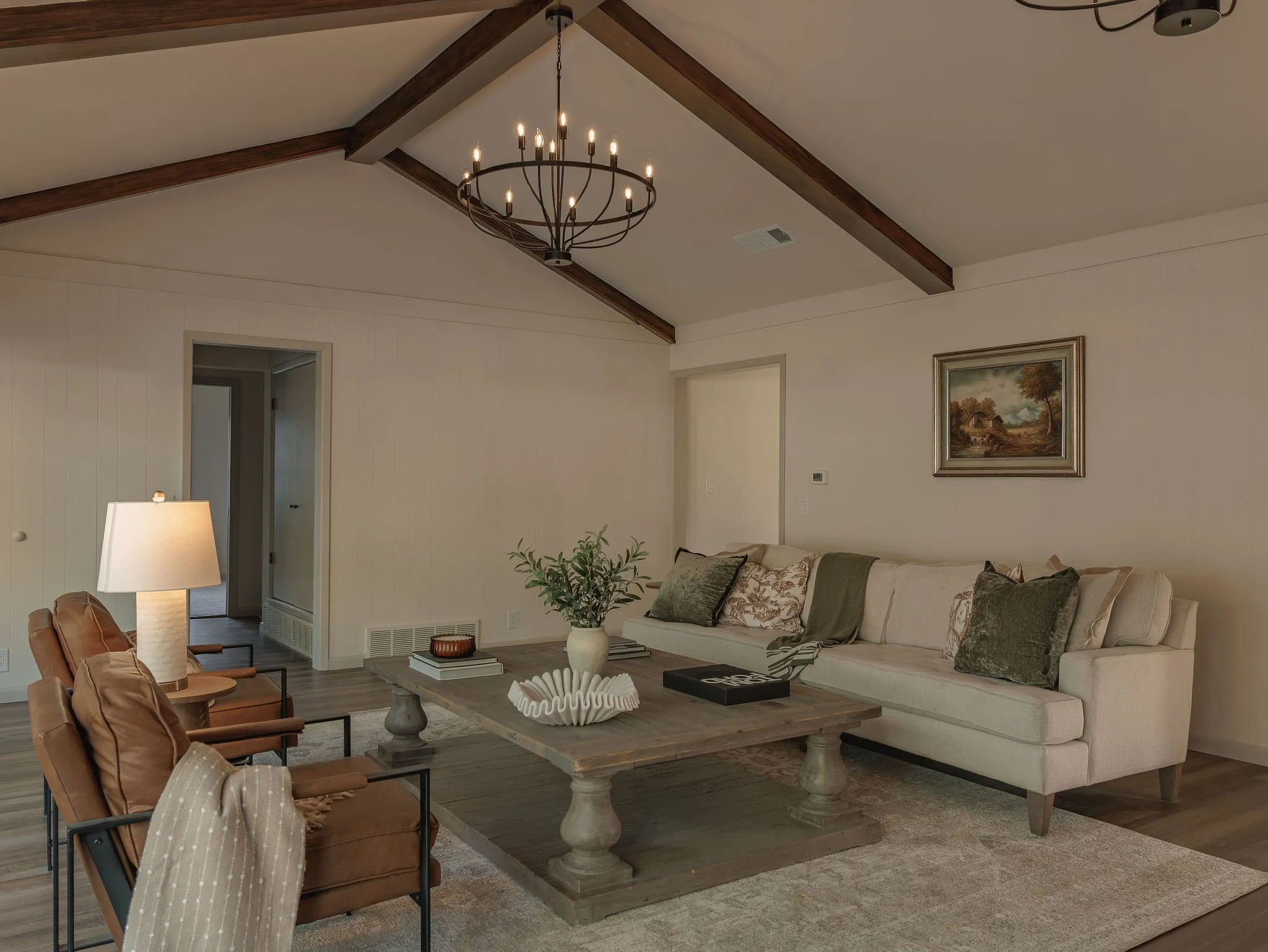 Vaulted ceilings and exposed wood beams bring architectural character and a sense of scale to the main living room.