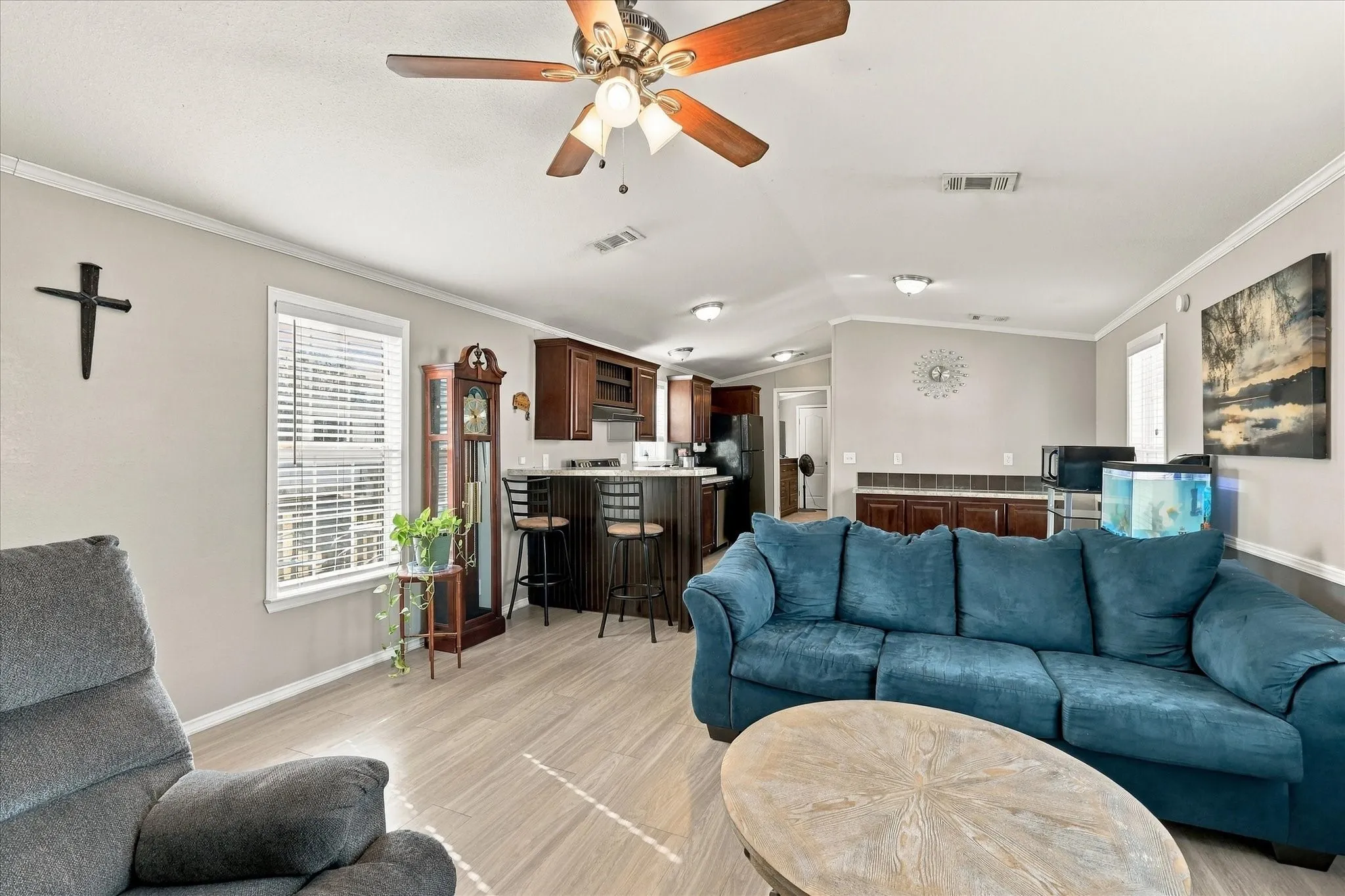 Open-concept living space featuring wood-finish flooring, a ceiling fan, and recessed lighting