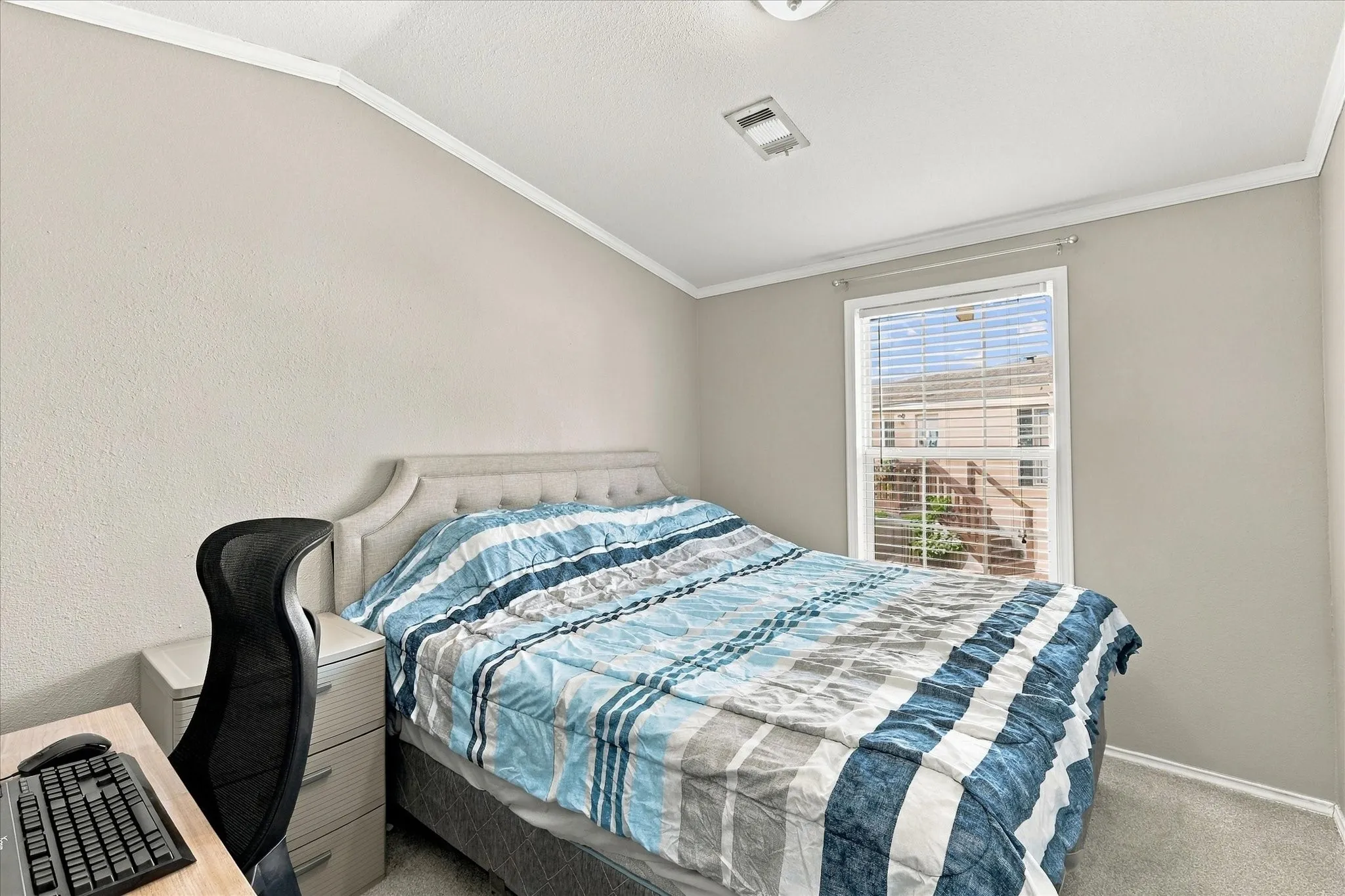 Window with horizontal blinds, textured walls, and carpet flooring