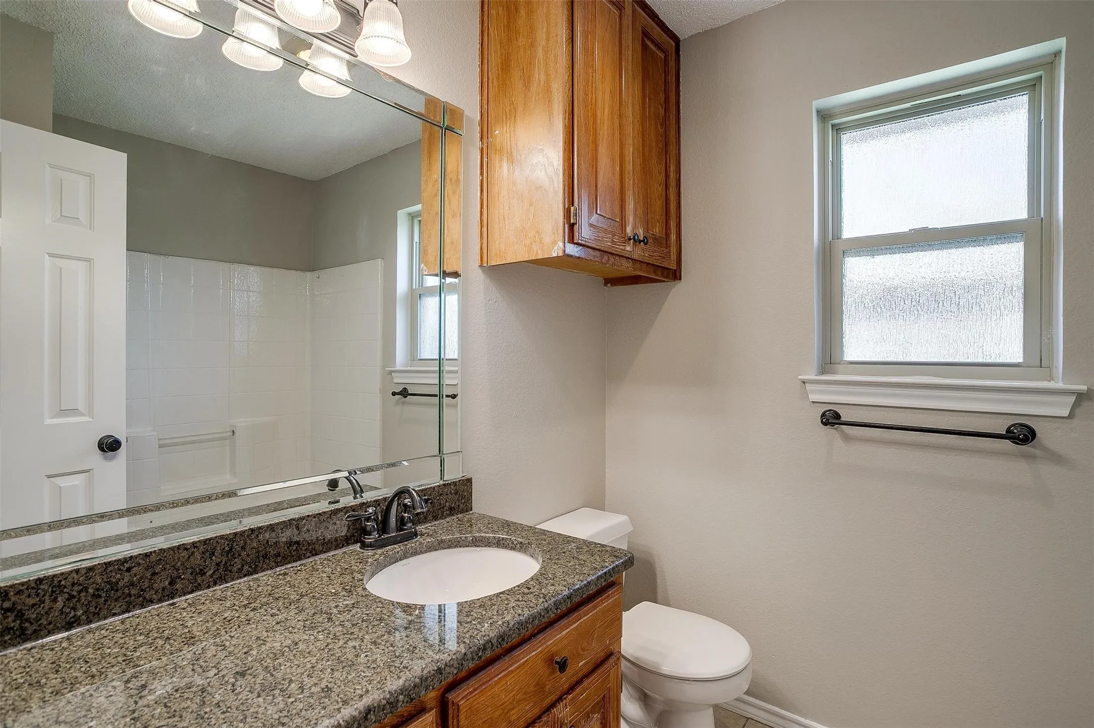 Vanity with granite-style countertop and integrated sink
