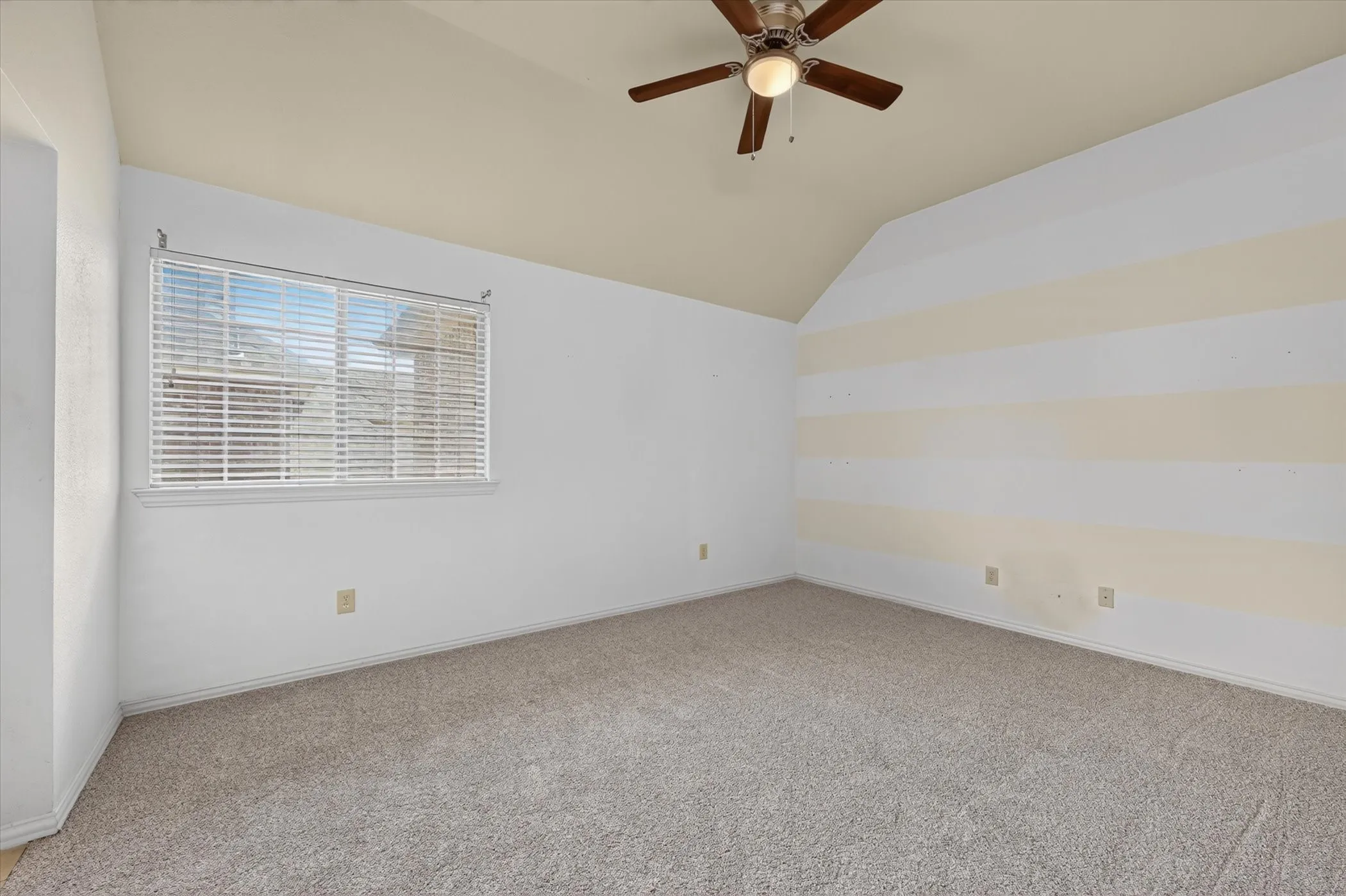 Carpeted flooring with a window featuring horizontal blinds