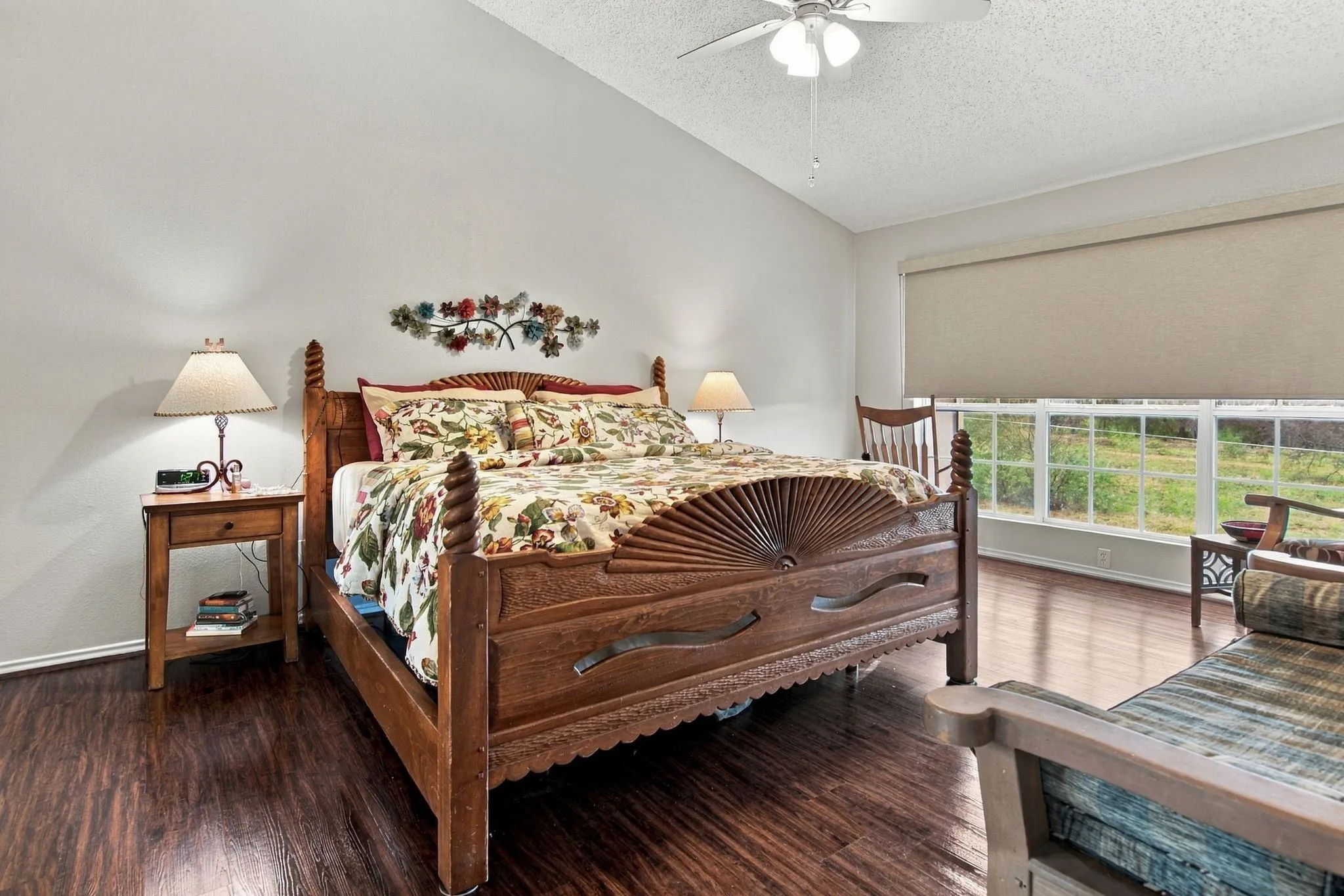 Wood-finish flooring, vaulted ceiling, and transom windows with roller shades
