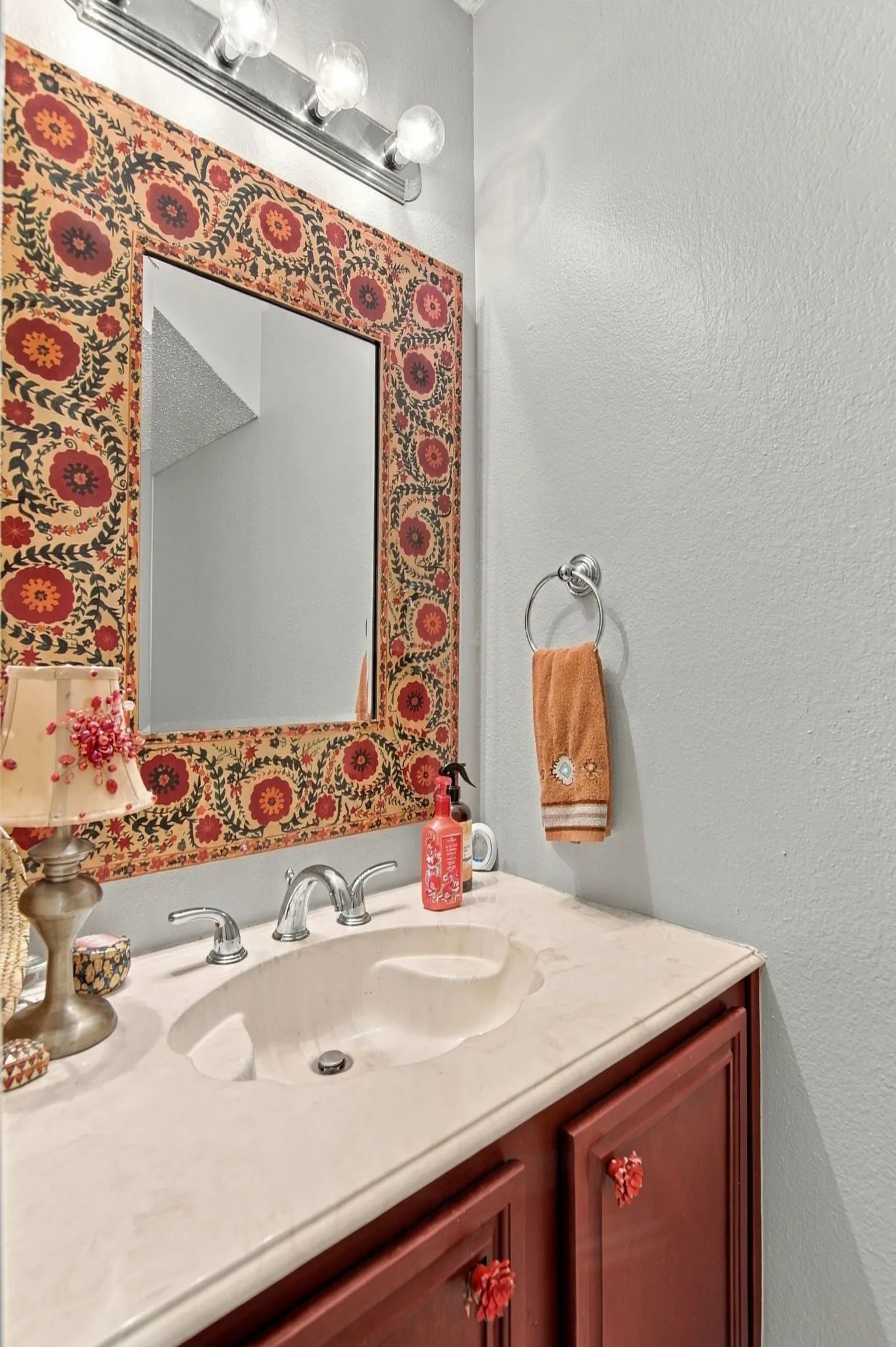 1/2 bath downstairs Vanity with an integrated sink, polished chrome faucet, and a wall-mounted light fixture