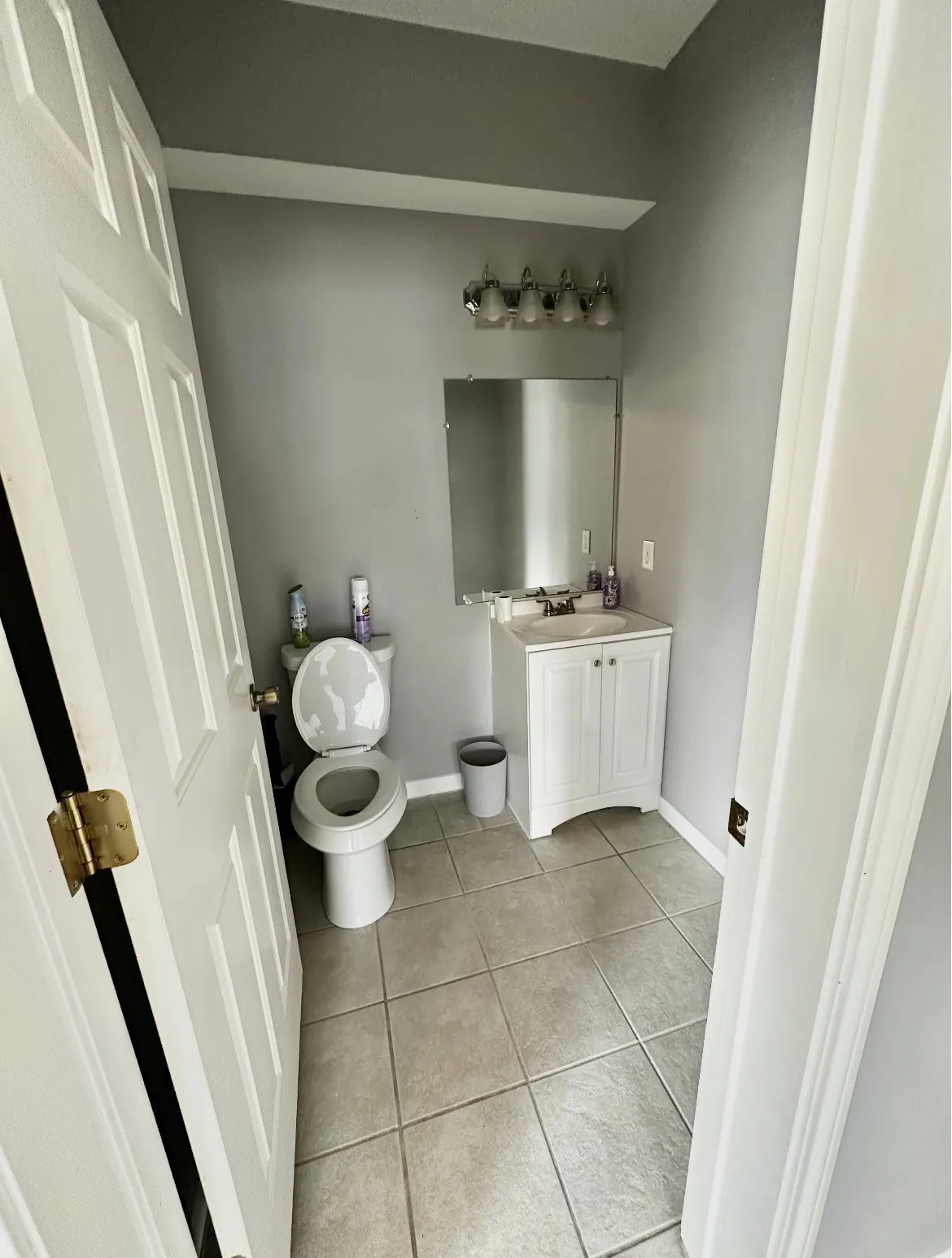 Tile flooring with a white vanity and integrated sink