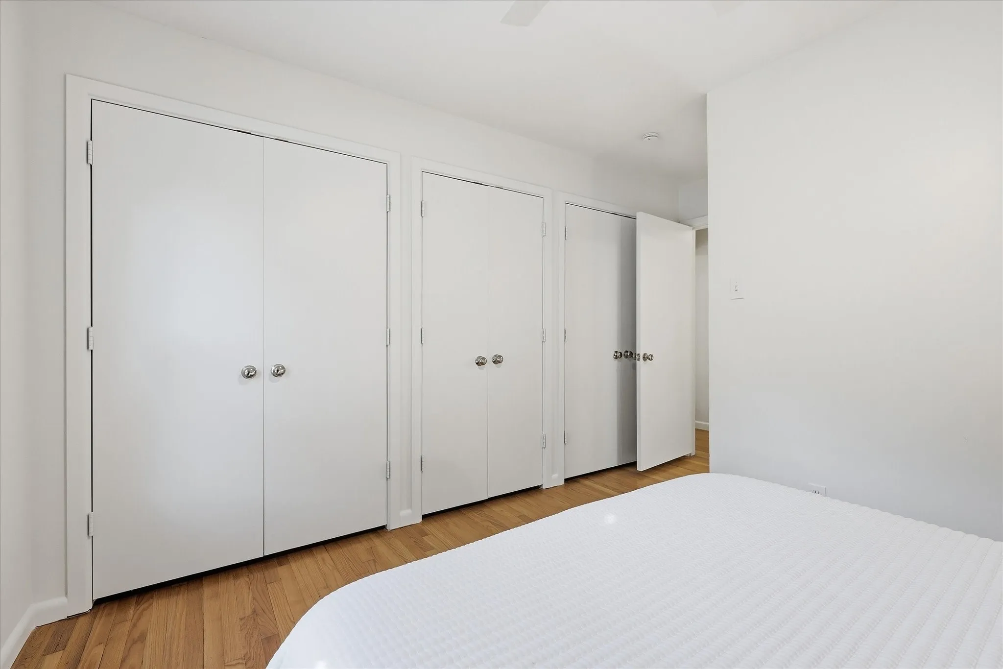 Primary bedroom has a wall of closets with space for a dresser inside