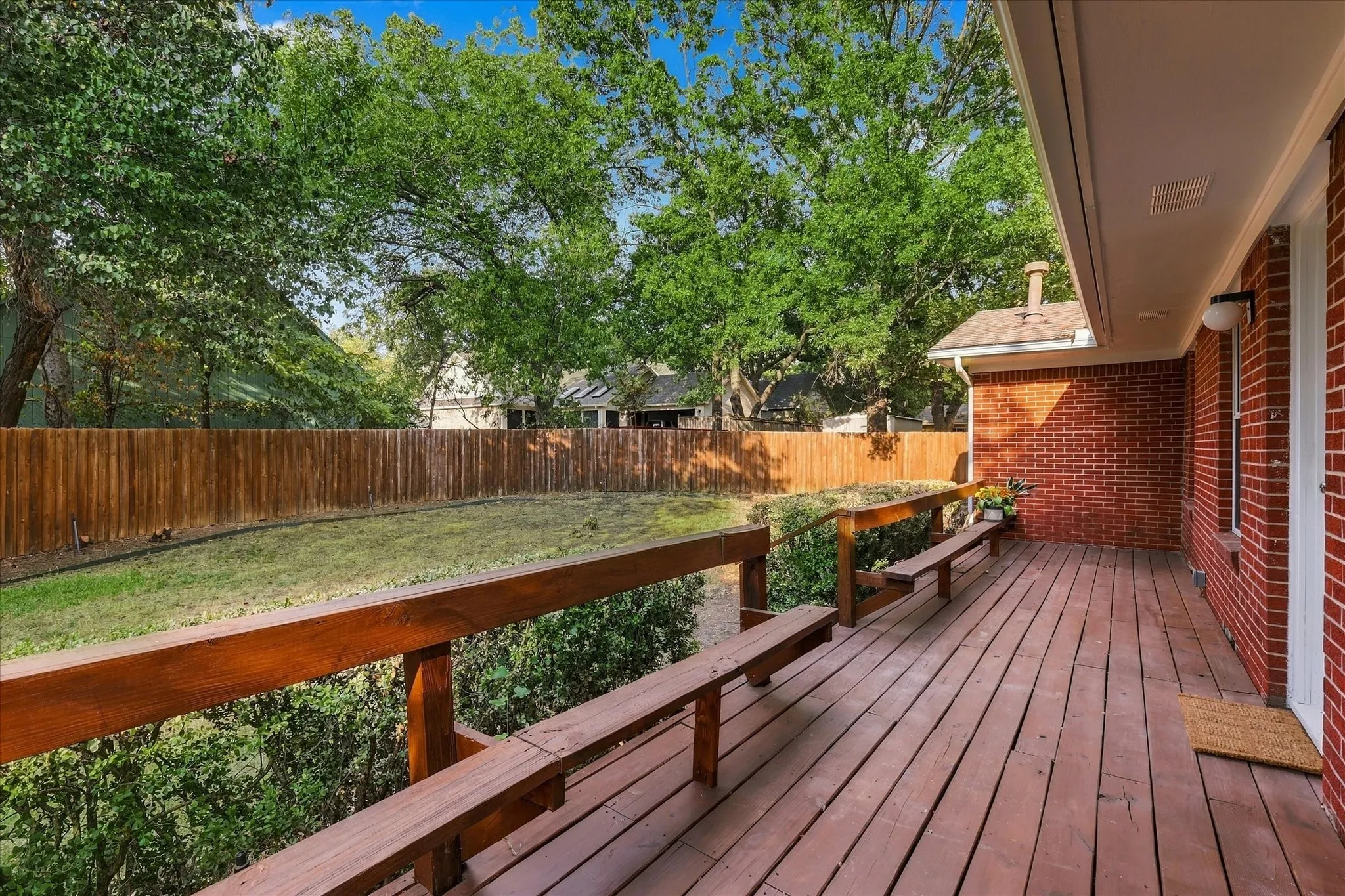 Great outdoor space with wood deck and fenced backyard