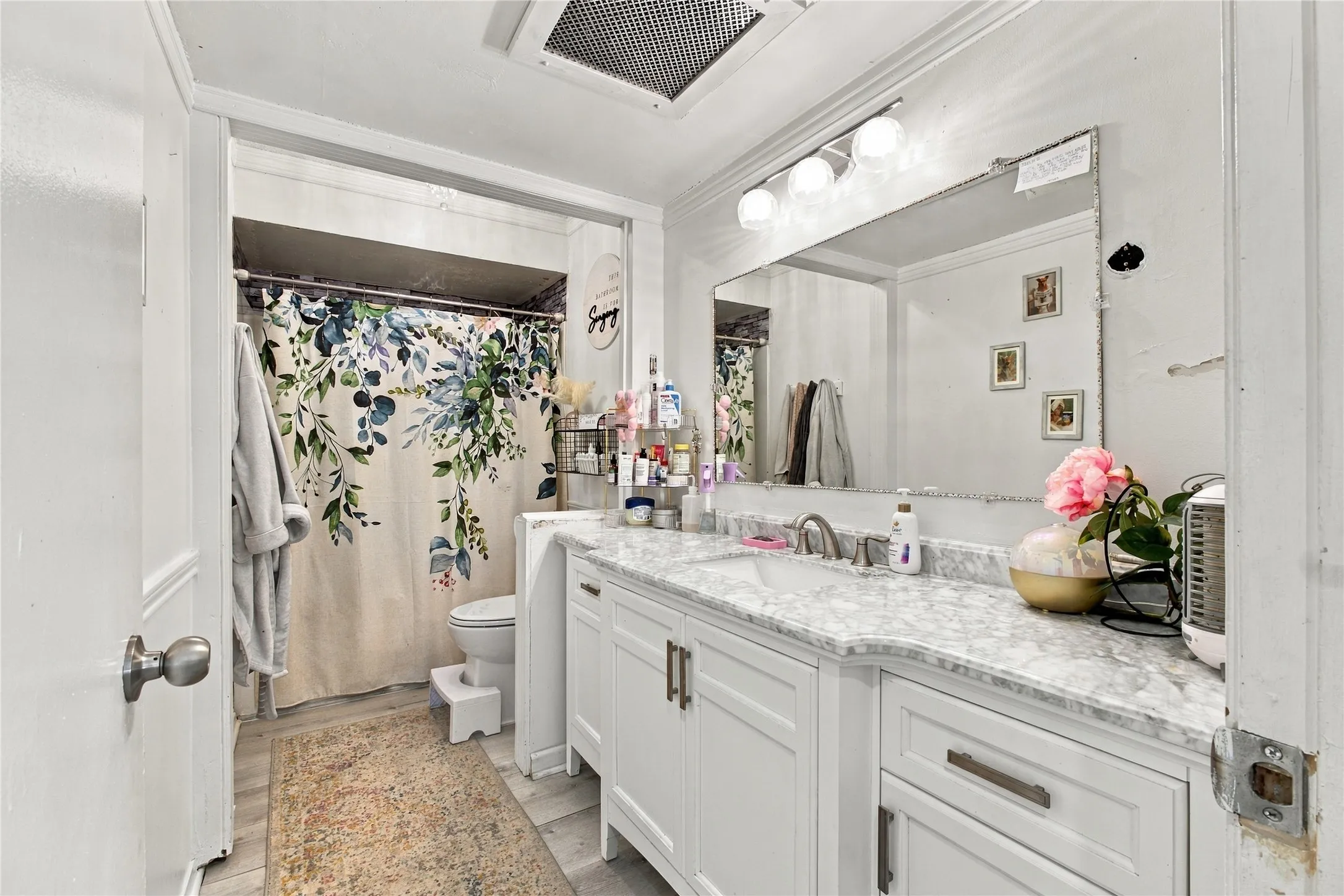 White vanity with a light-toned countertop, double sinks, and brushed nickel hardware