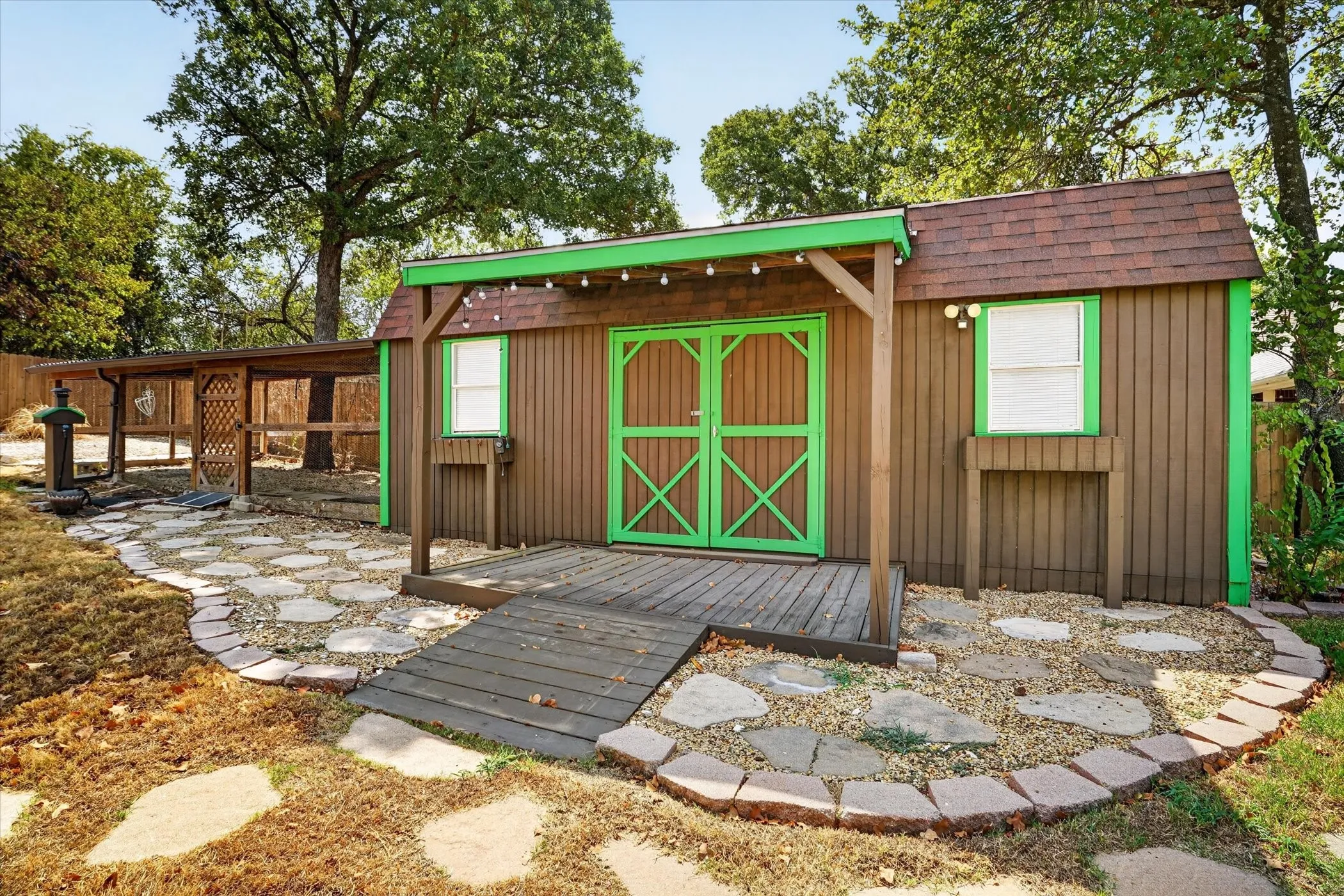 Freestanding structure with a wood exterior, gabled roof, and double doors