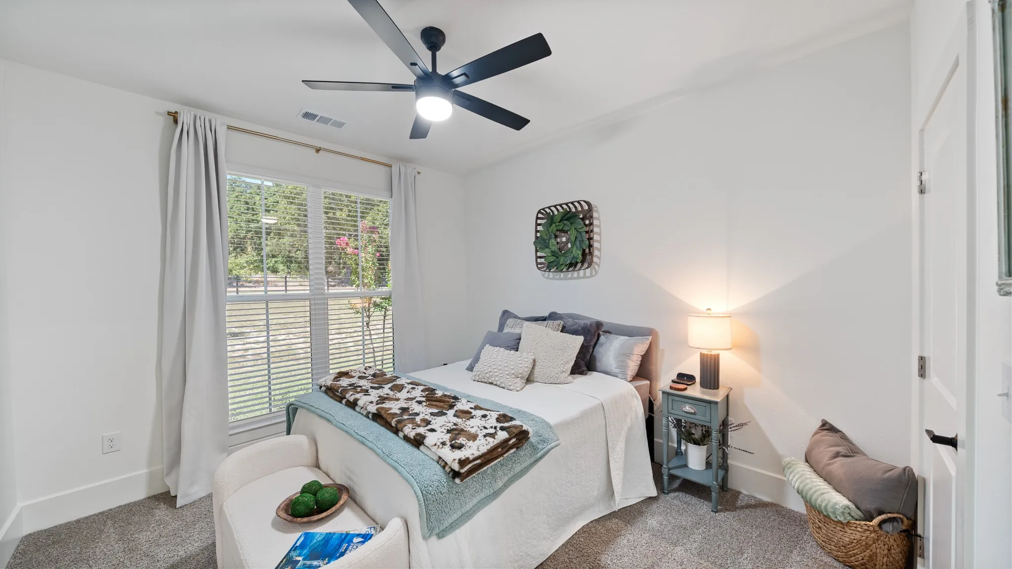 Recessed lighting with a ceiling fan, white paneled door with black hardware, and a window with blinds
