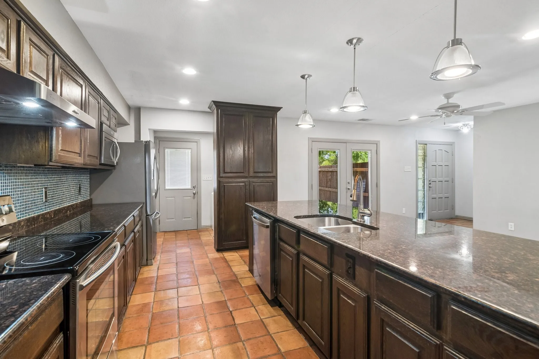 Lots of cabinet space, pantry, refrigerator and door leads out to side yard