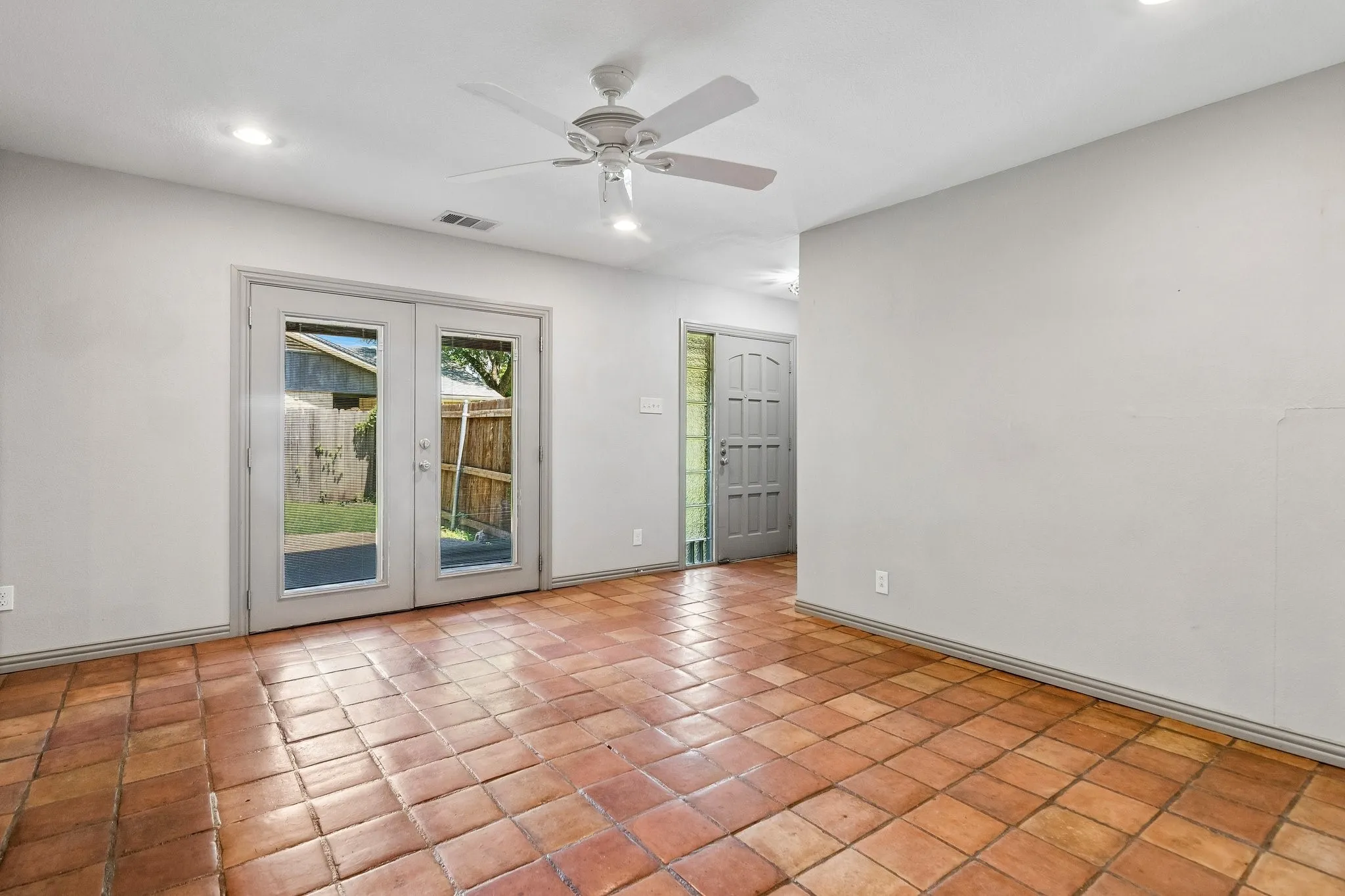 Dining room with Saltillo tiles and ceiling fan opens to the patio