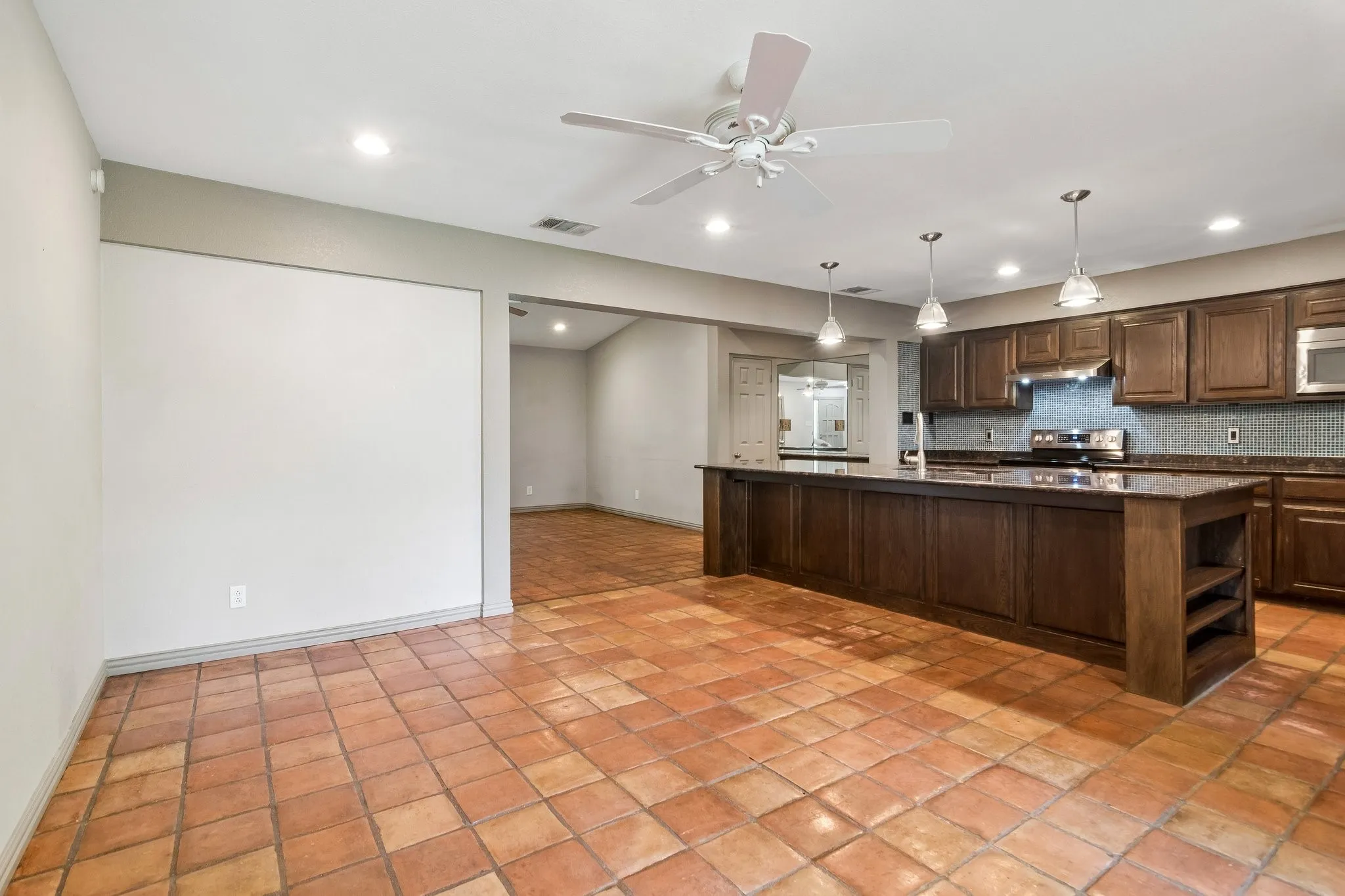 Beautiful kitchen open to living and dining room features large Island