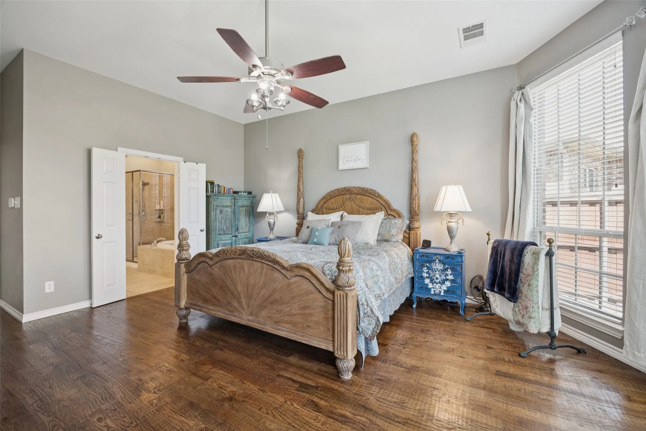 Wood-finish flooring with a ceiling fan light fixture