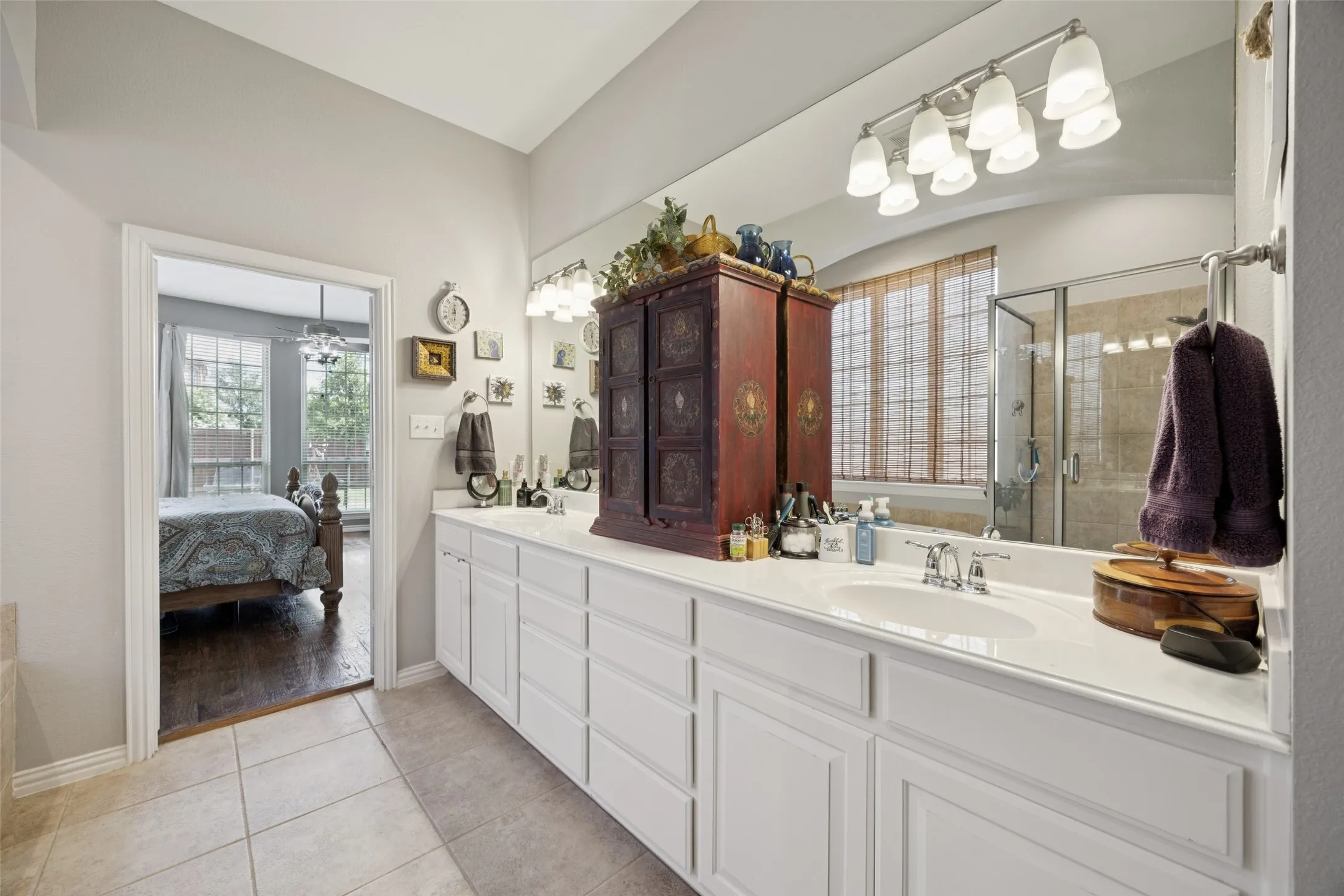 Dual vanity with integrated sinks, extensive counter space, and tiled flooring