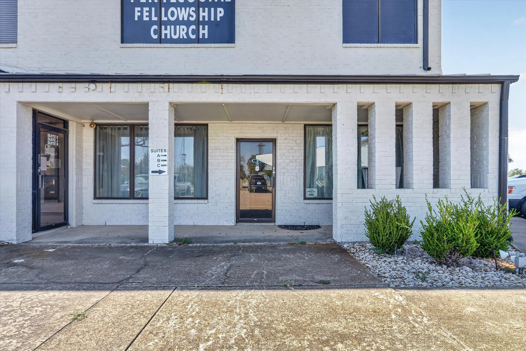 White brick exterior with prominent signage