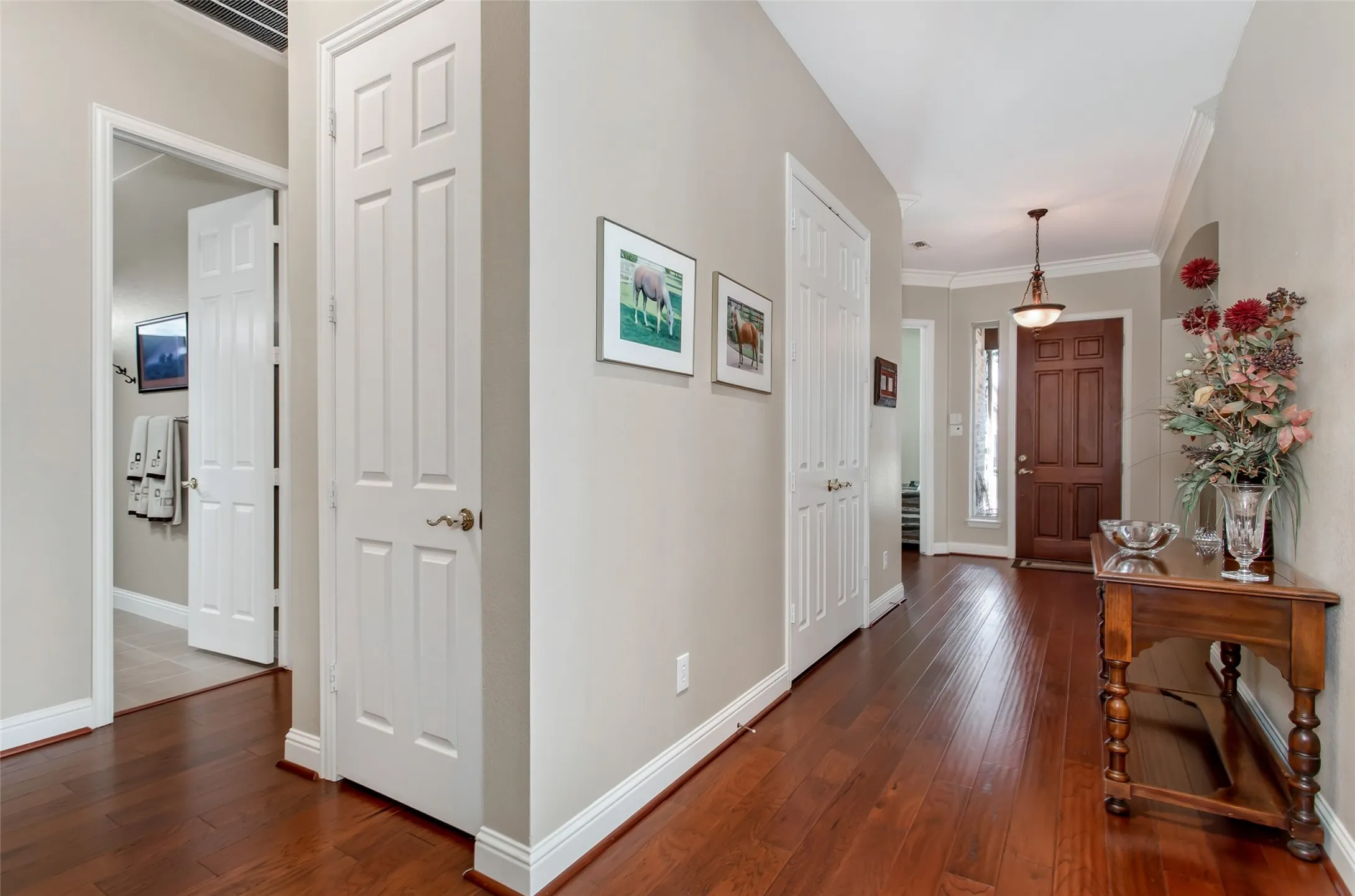 Wood-finish flooring throughout the hallway