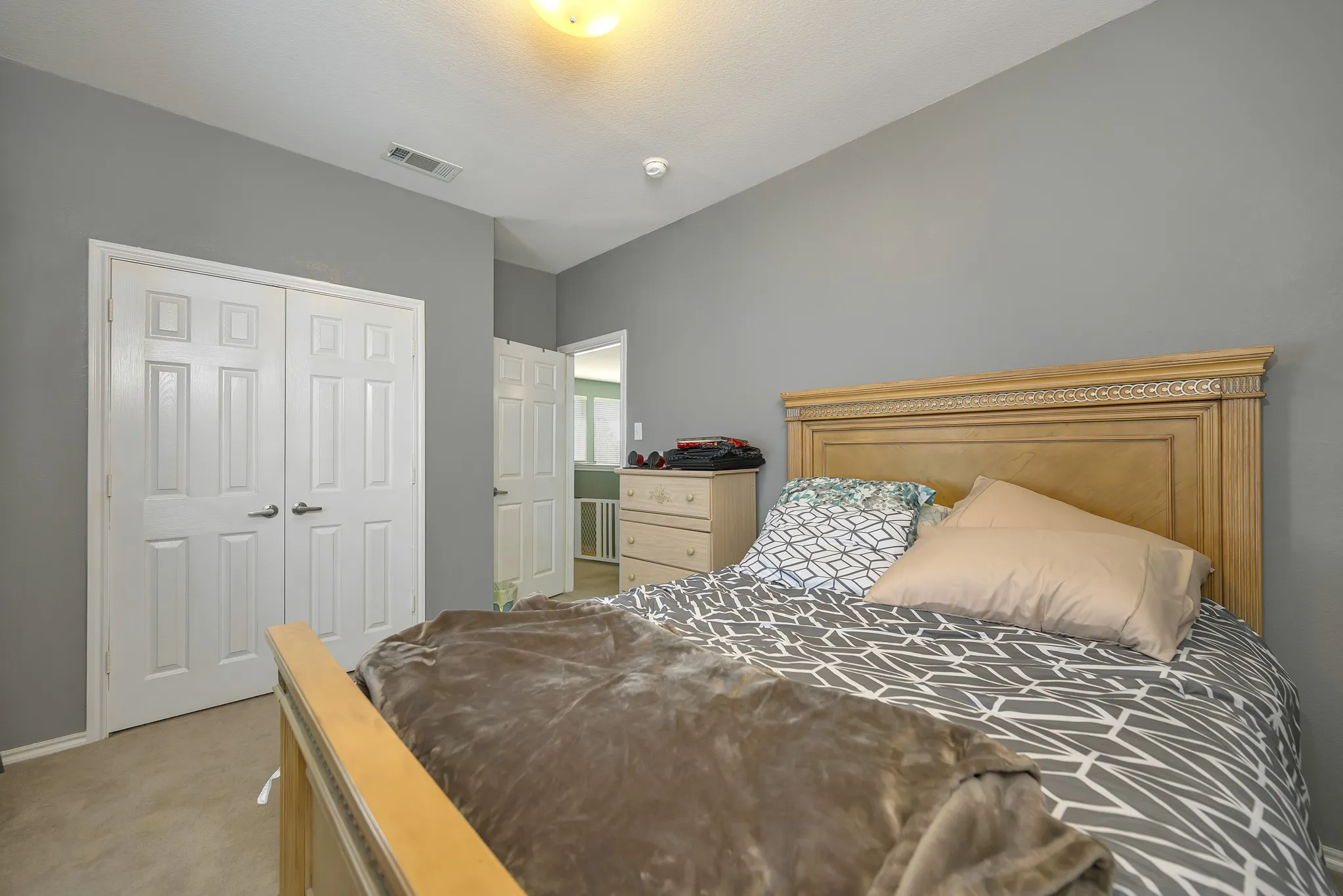 Recessed lighting, light gray wall color, paneled interior doors, and carpet flooring