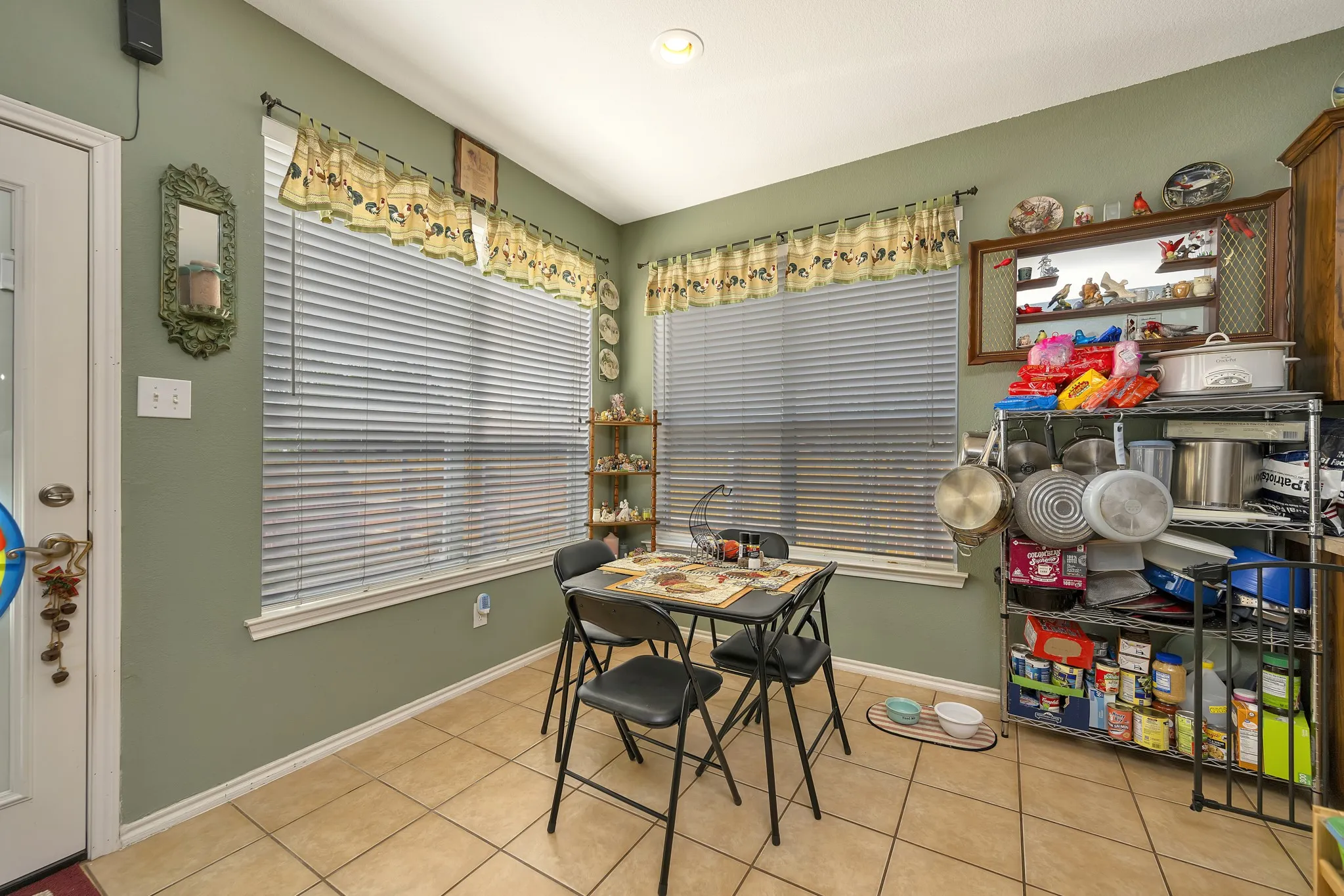 Tile flooring throughout, two large windows.