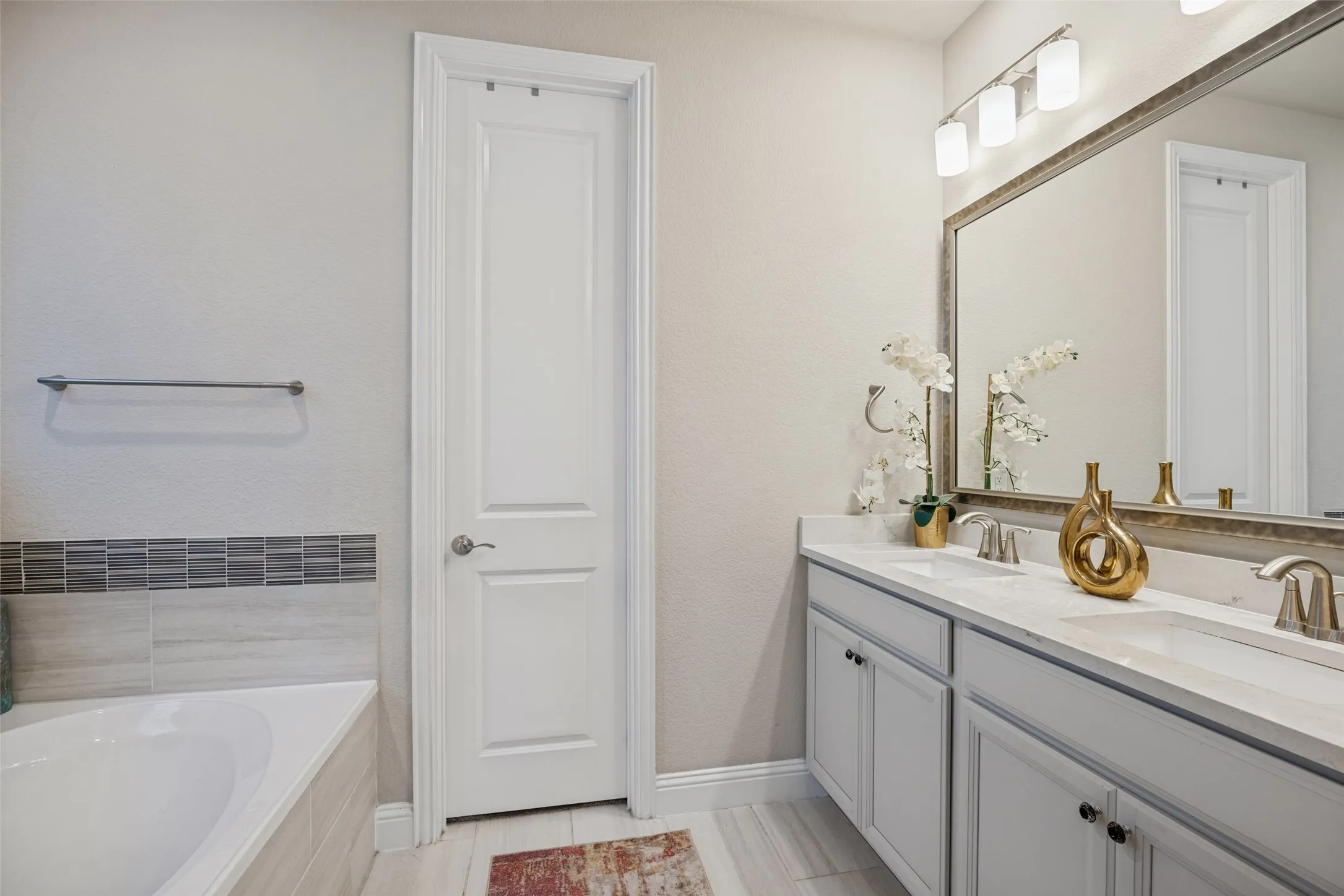 Dual vanity with undermount sinks, stone countertop, and brushed nickel fixtures