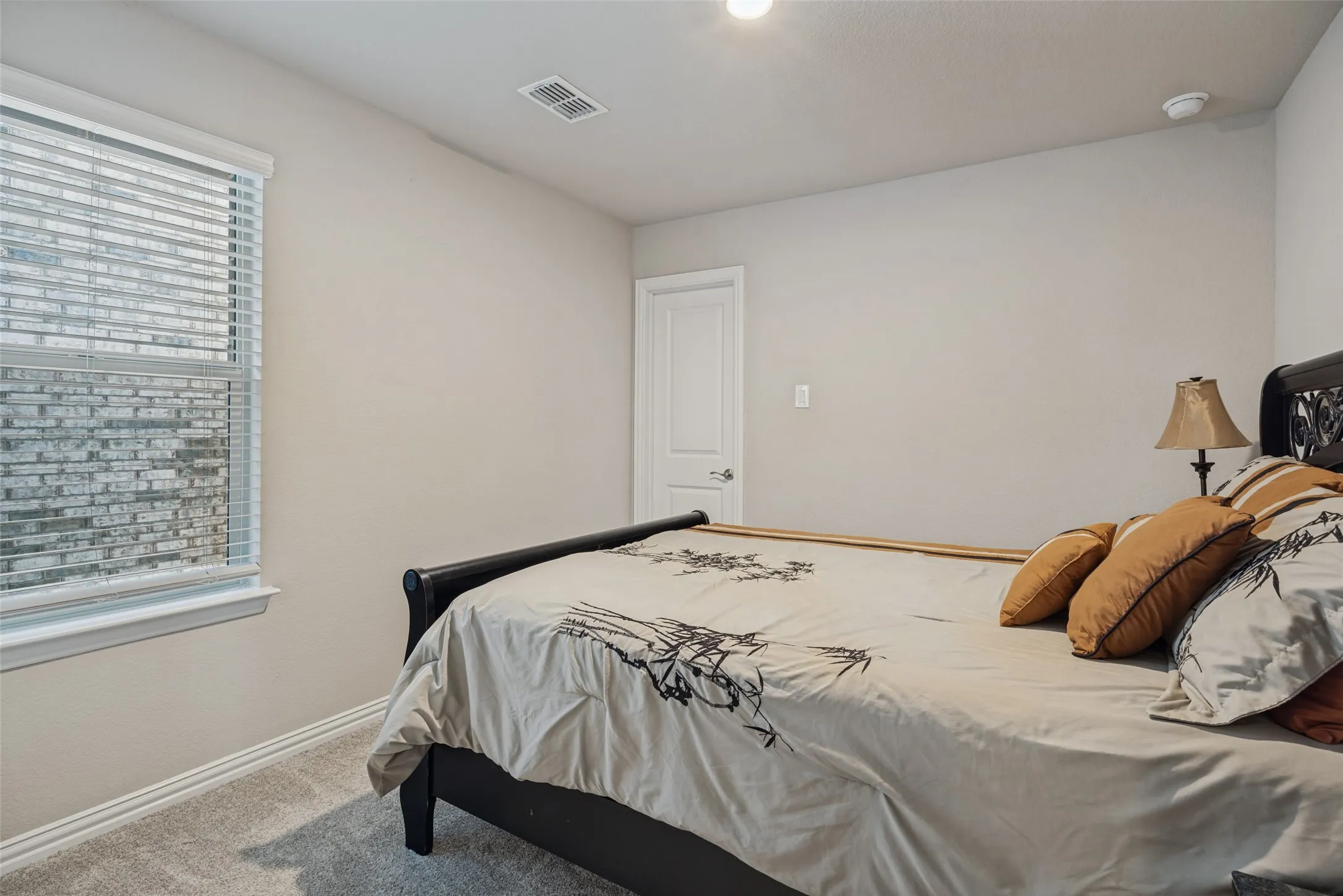 Window with horizontal blinds, light gray wall paint, and gray carpet flooring