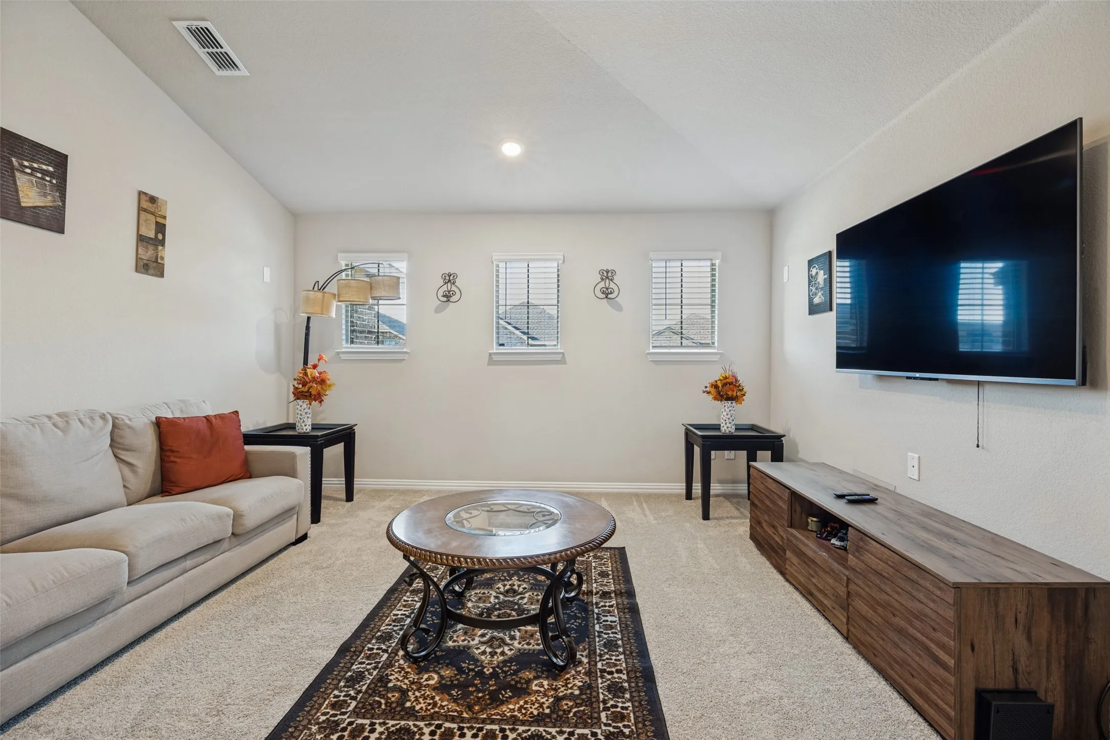 Carpeted flooring with multiple windows featuring blinds