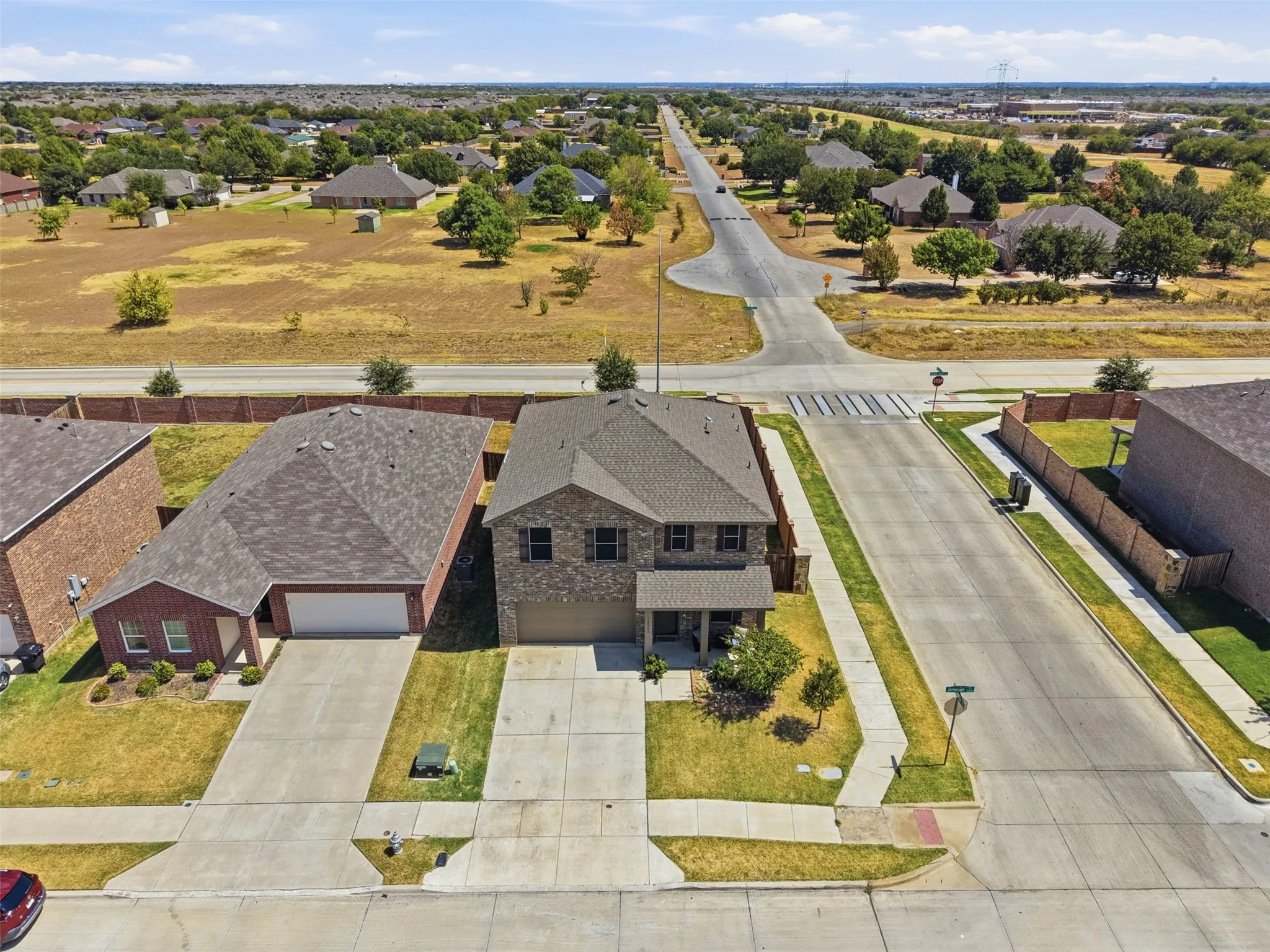 Two-story residence with brick facade and shingle roof
