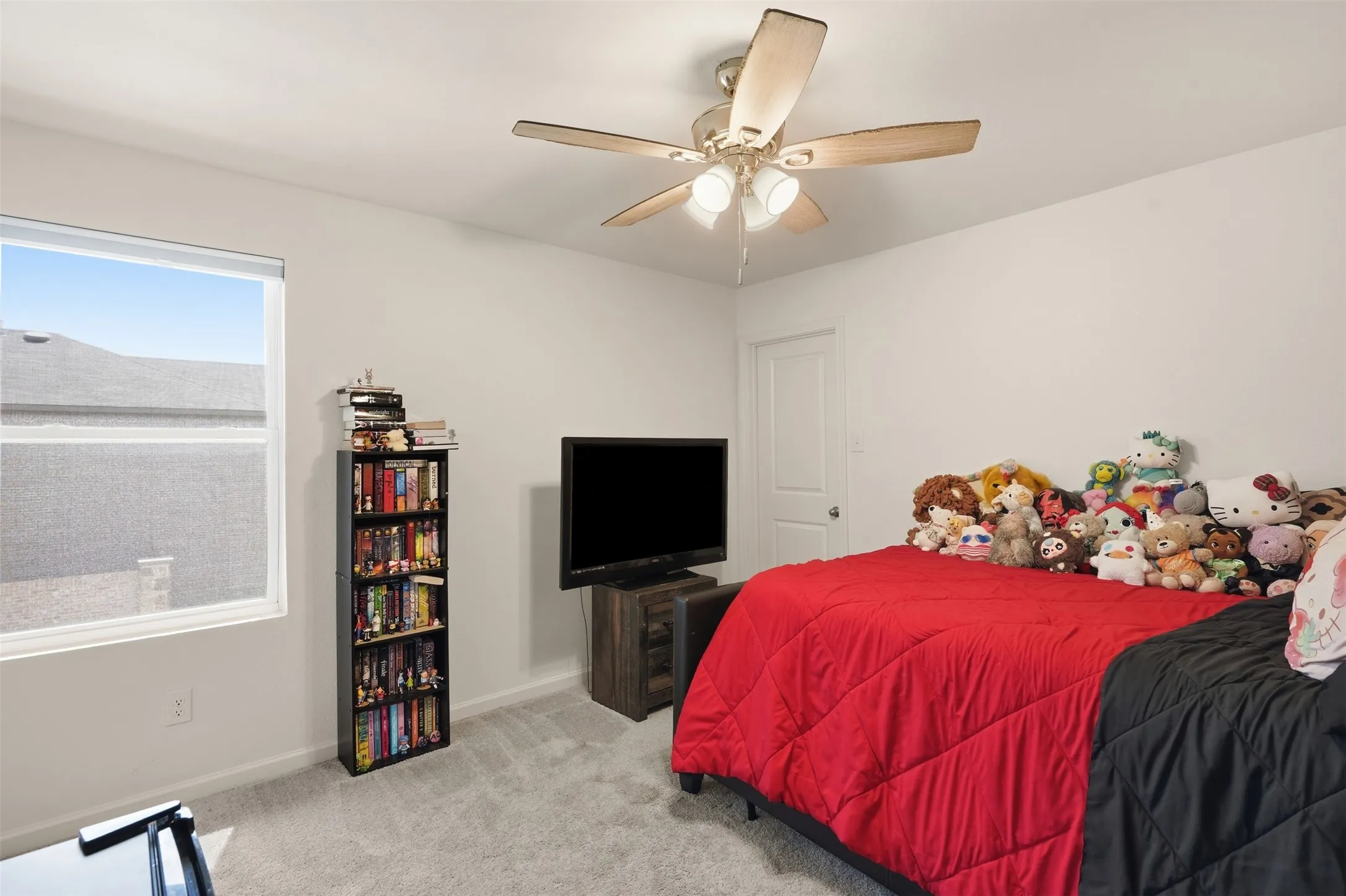 Recessed window with white trim, light gray wall-to-wall carpeting, and a ceiling fan with integrated lighting