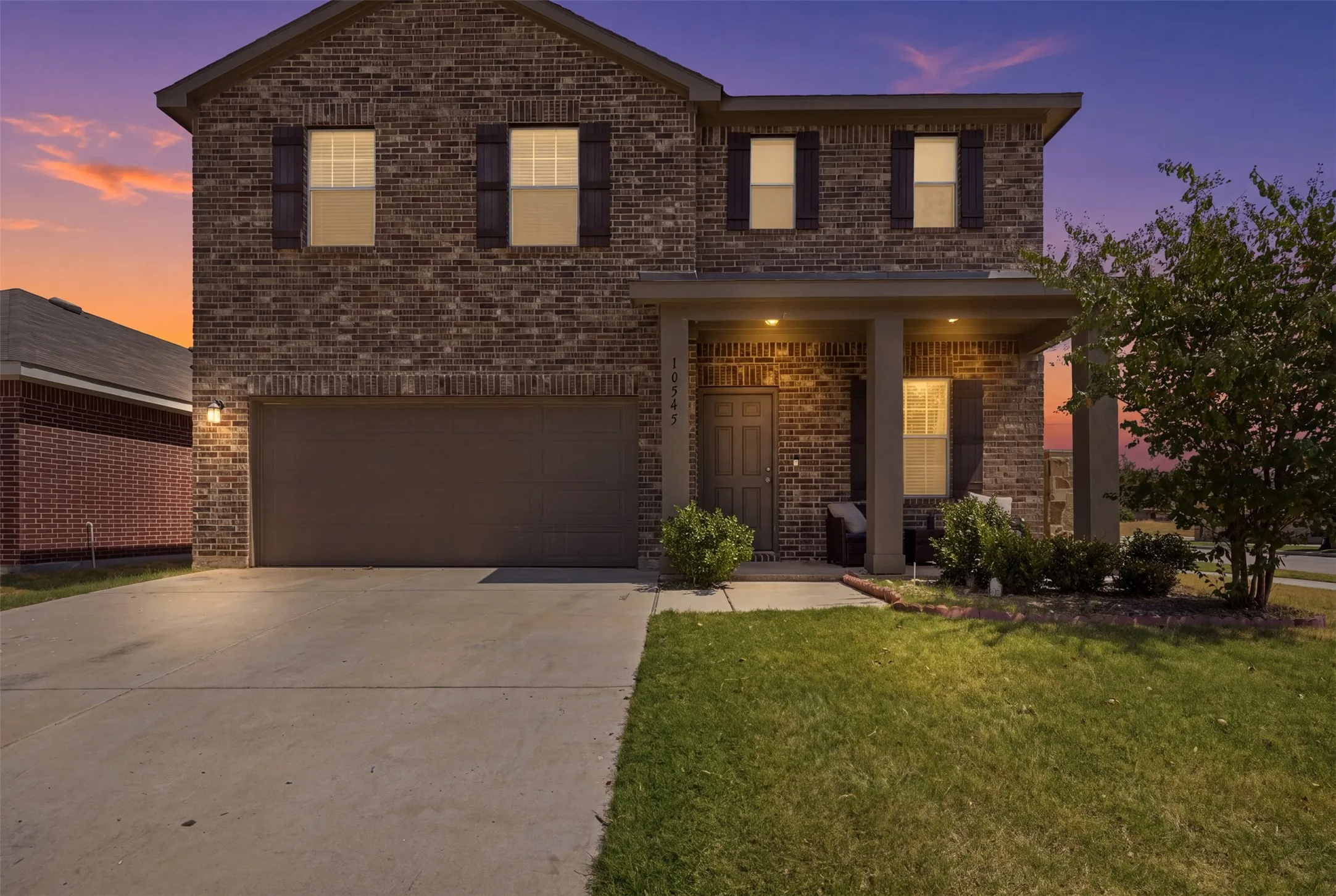 Brick facade with a covered front porch featuring square columns