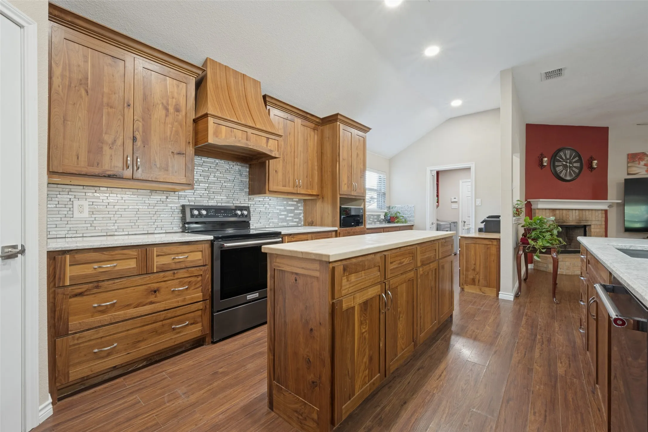Beautifully updated rustic walnut cabinets with granite countertops and large butcher block island.