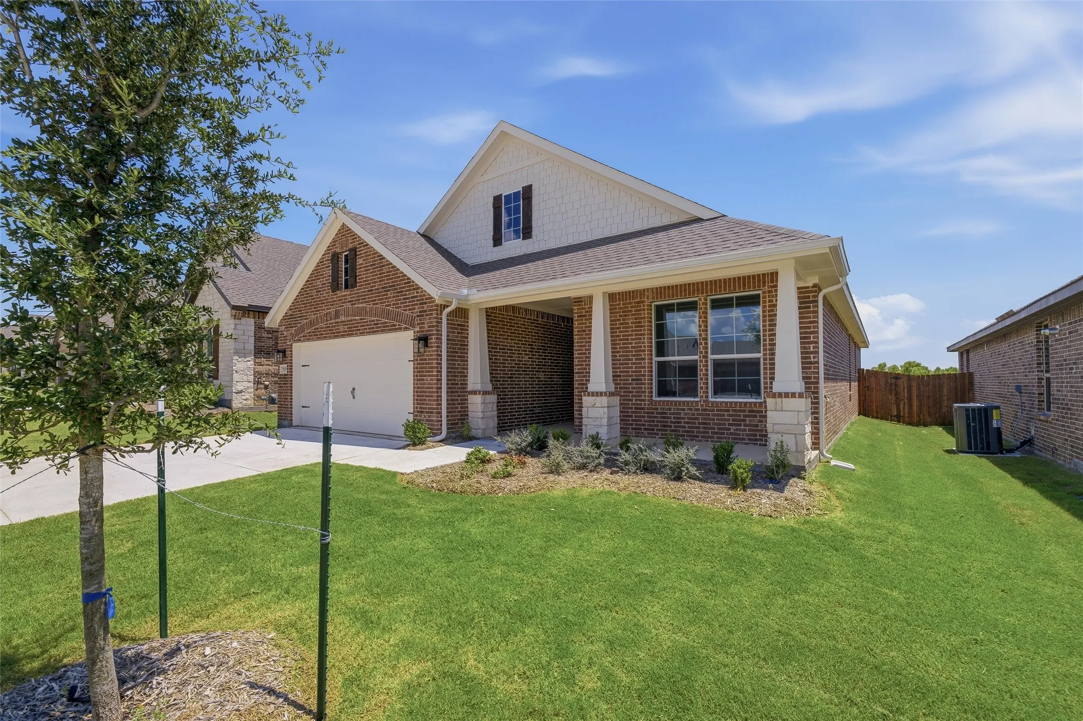 Brick exterior with white siding accents and dark brown shutters