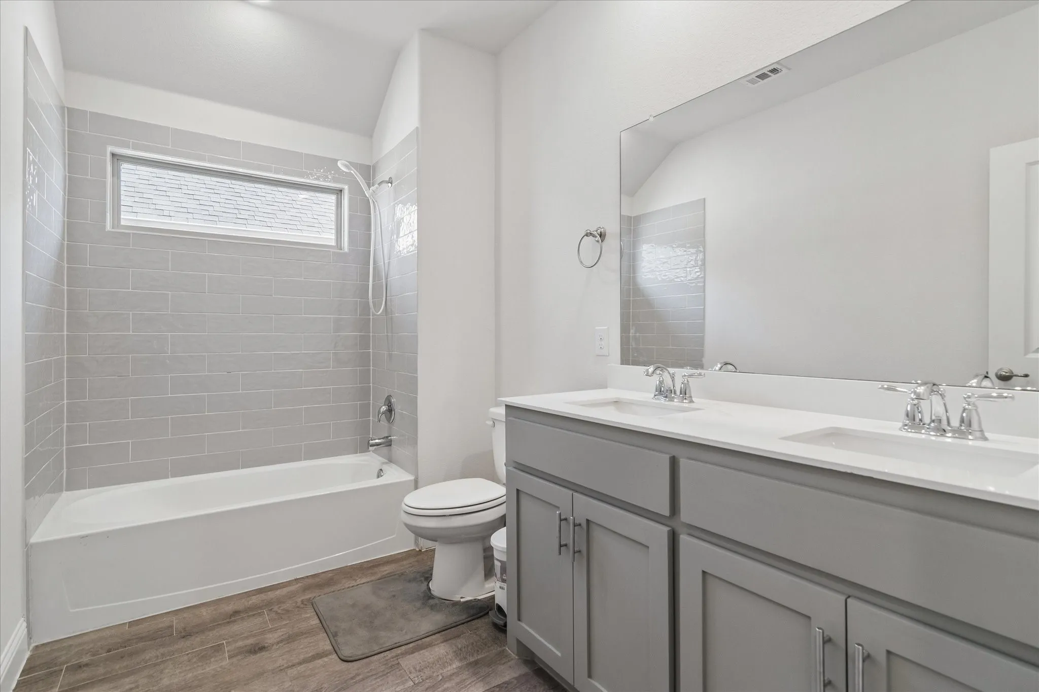 Dual vanity with gray cabinetry and white countertops