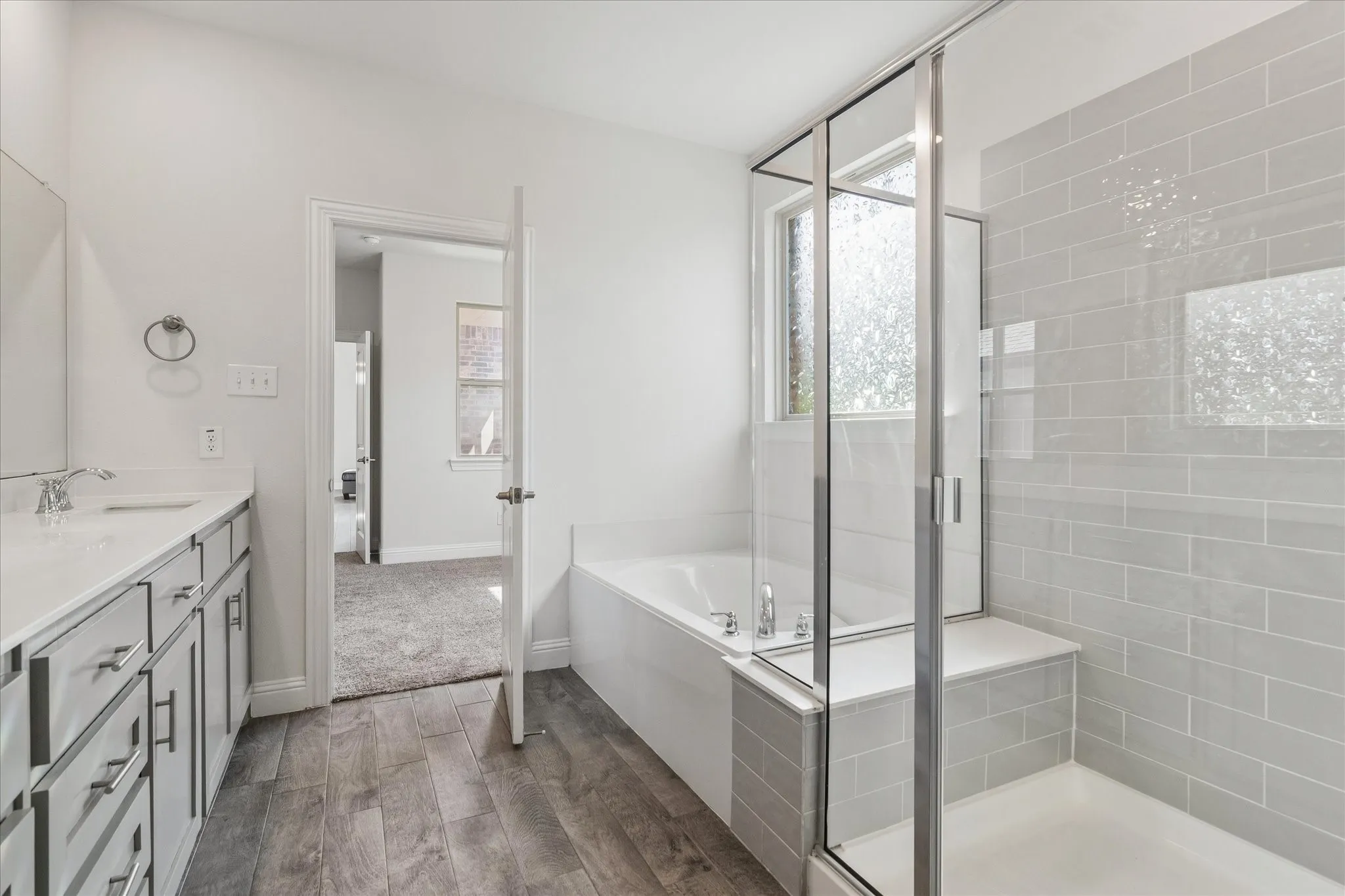 Frameless glass shower enclosure with a built-in bench