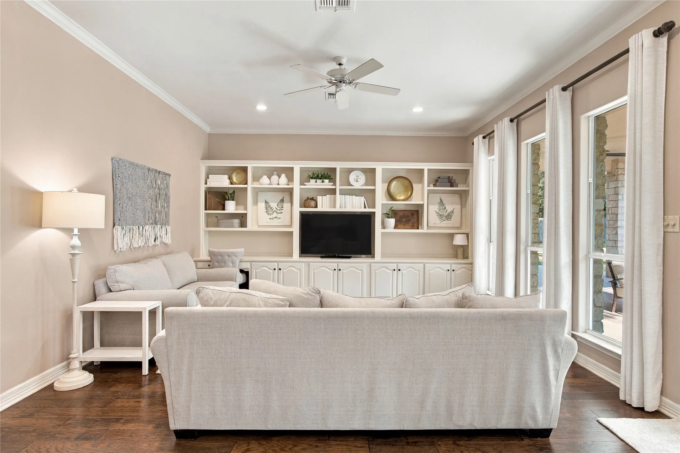 Built-in shelving with lower cabinetry, recessed lighting, and wood-finish flooring