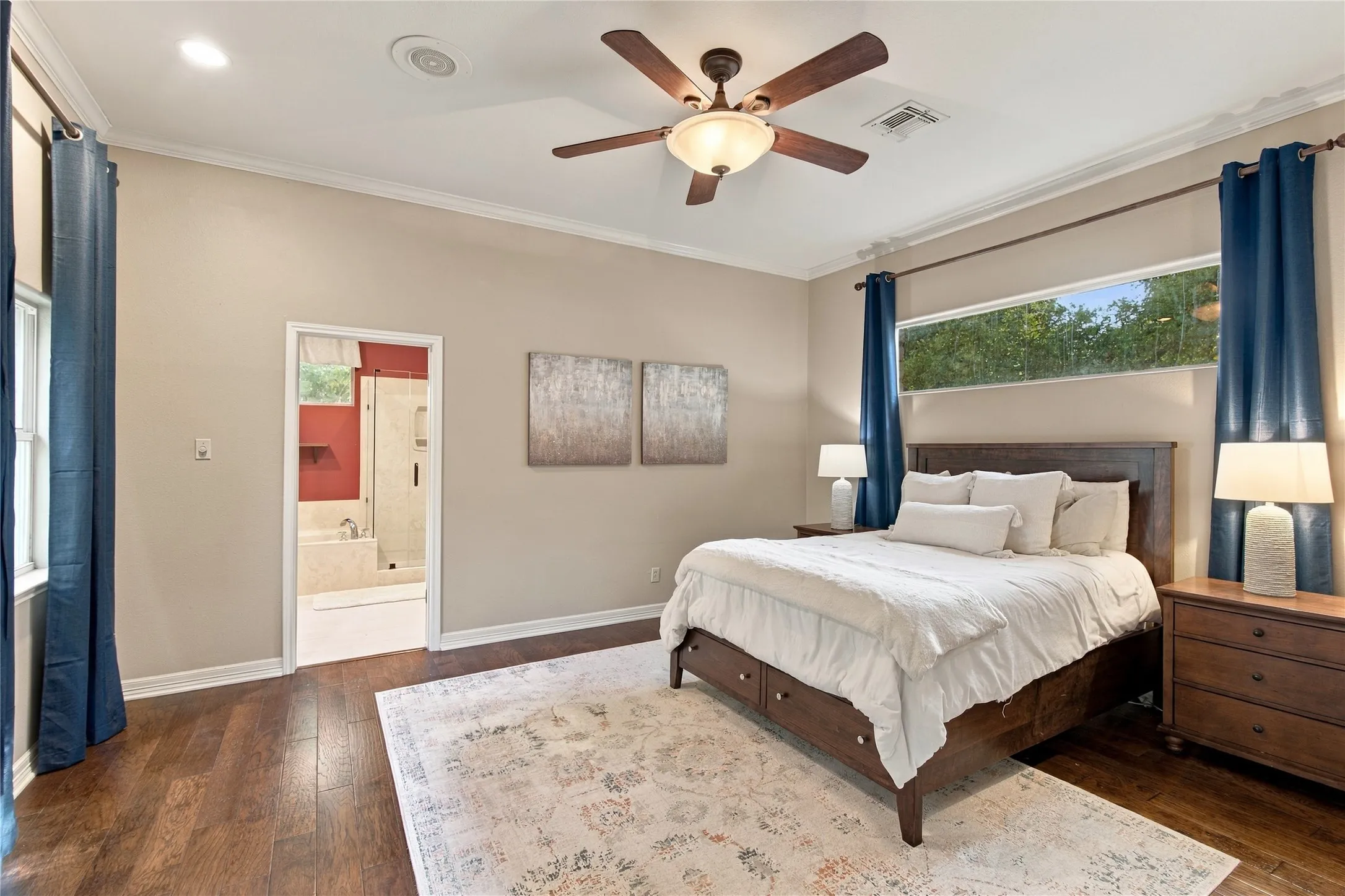 Vaulted ceiling, wood-finish flooring, ceiling fan with integrated lighting, transom window, and a recessed ceiling light