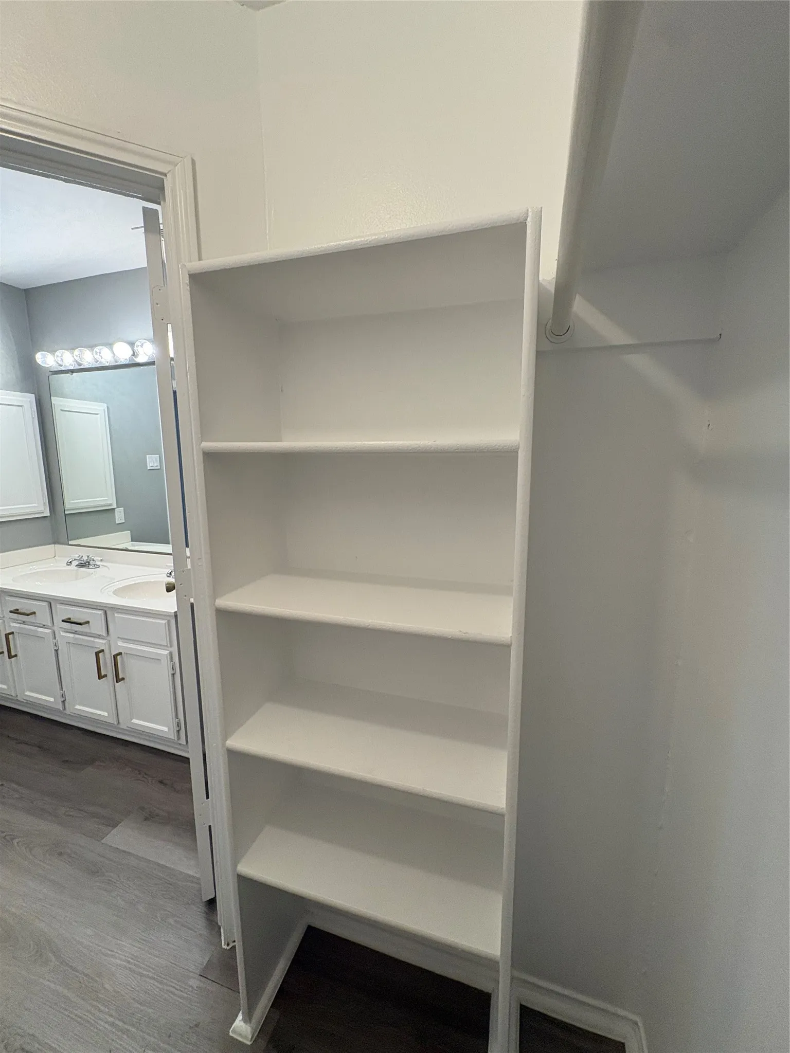 Built-in shelving unit with five white shelves