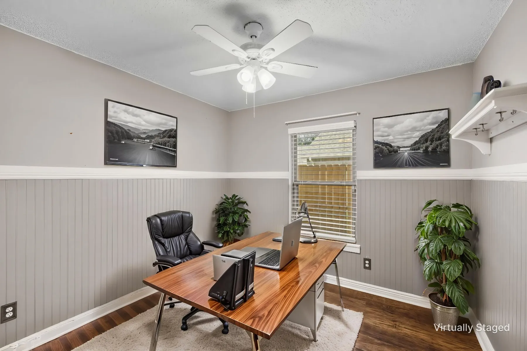 Virtually staged photo - secondary bedroom showcasing what a home office space could look like.