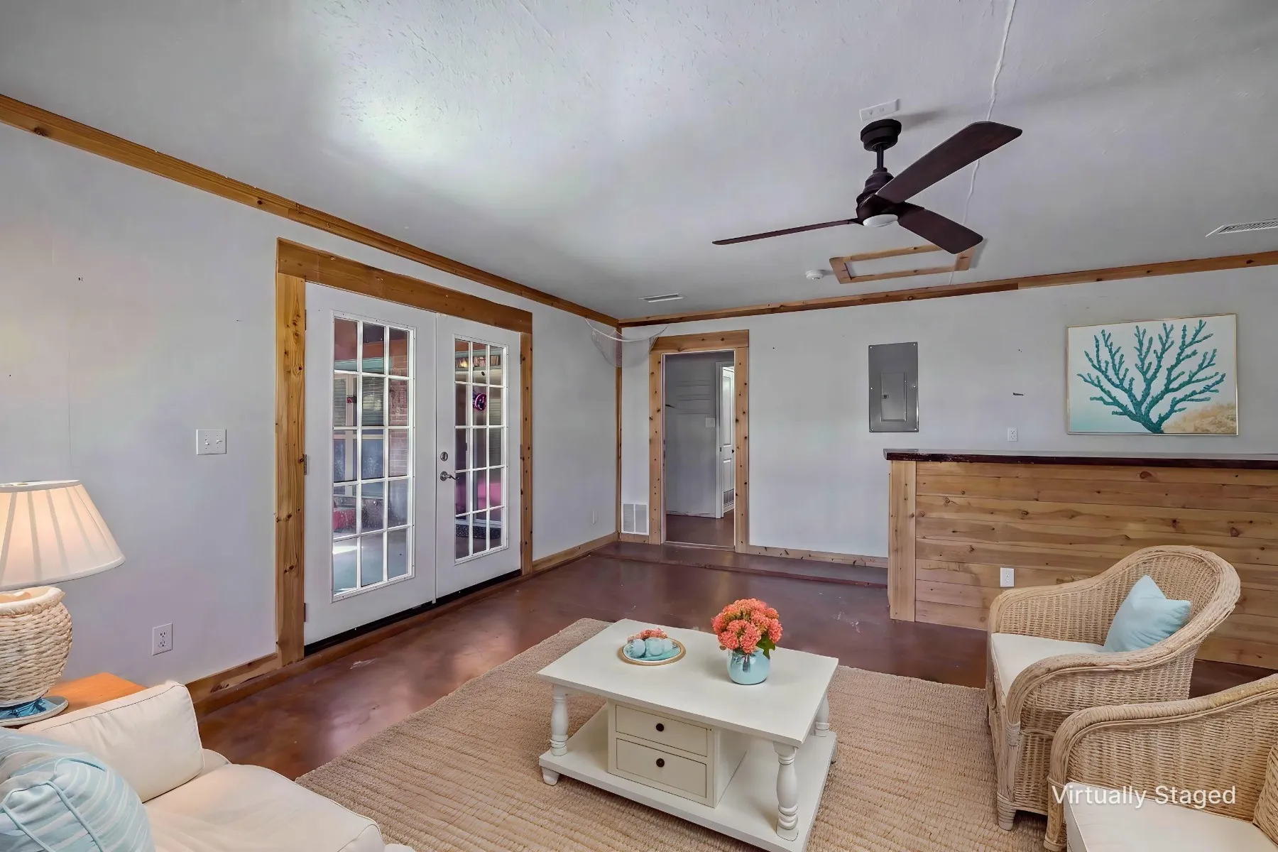 Virtually staged photo - Converted garage area showcasing what an additional living space with dry bar area could look like. French doors give direct access to oversized covered patio.