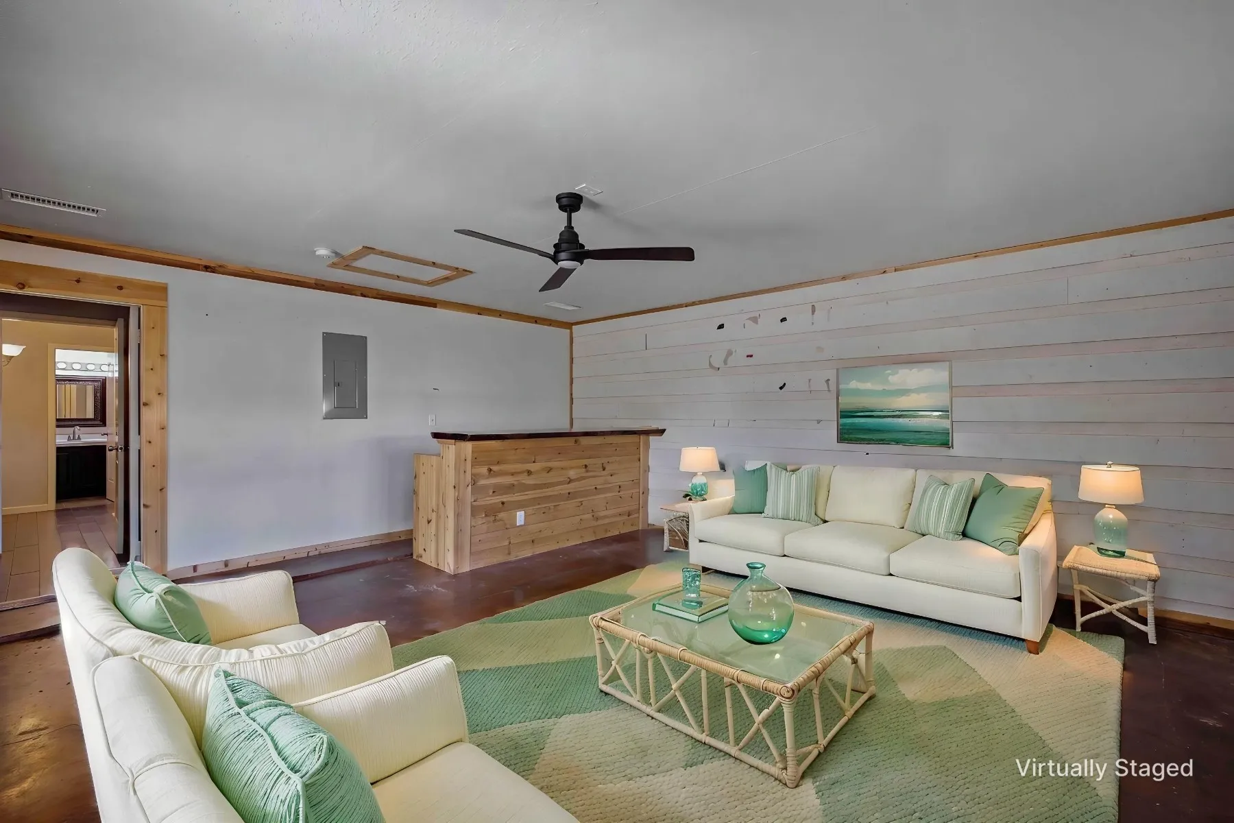 Virtually staged photo - Converted garage area showcasing what an additional living space with dry bar area could look like.